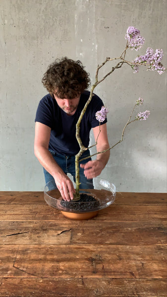 @the_ikebana_project placing the first branch on the kenzan in the NUDE Contour bowl for the Ikebana project