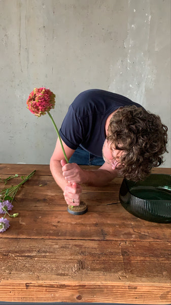 @the_ikebana_project placing the flowers on the kenzan for the Ikebana project for NUDE Glass