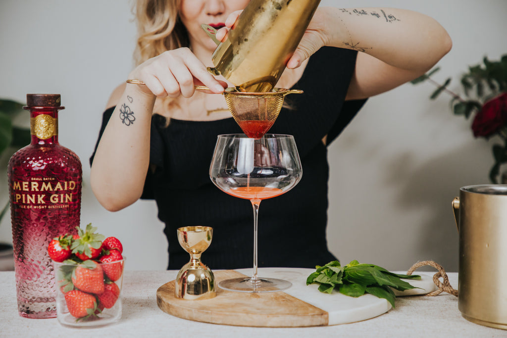 Camille Vidal creating the low abv cocktail, based on pink gin, strawberries and basil, in a NUDE Glass Stem Zero glass.