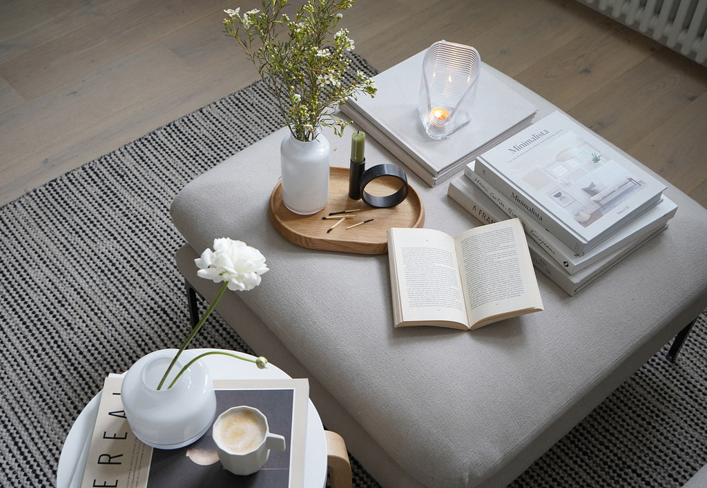 Lagom scenery with a cozy set up of sofa, coffee tables and NUDE vases in soft neutral colors