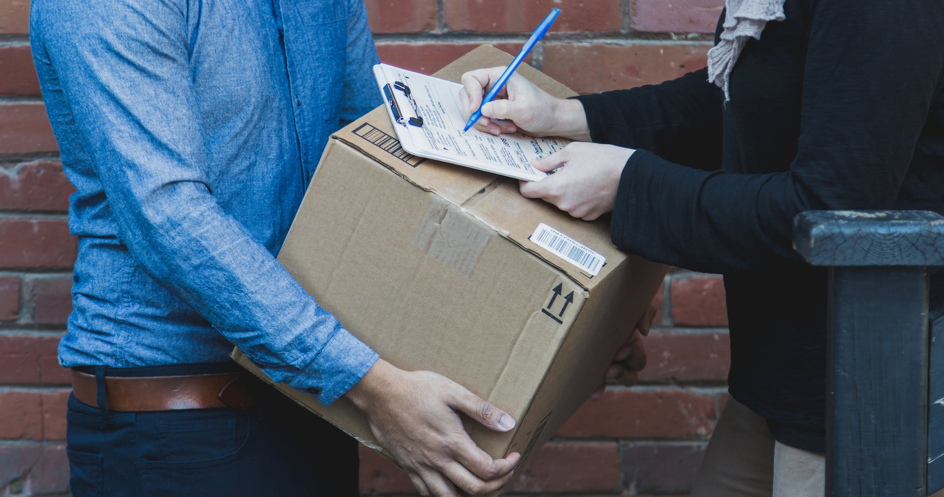 A customer signing for a package