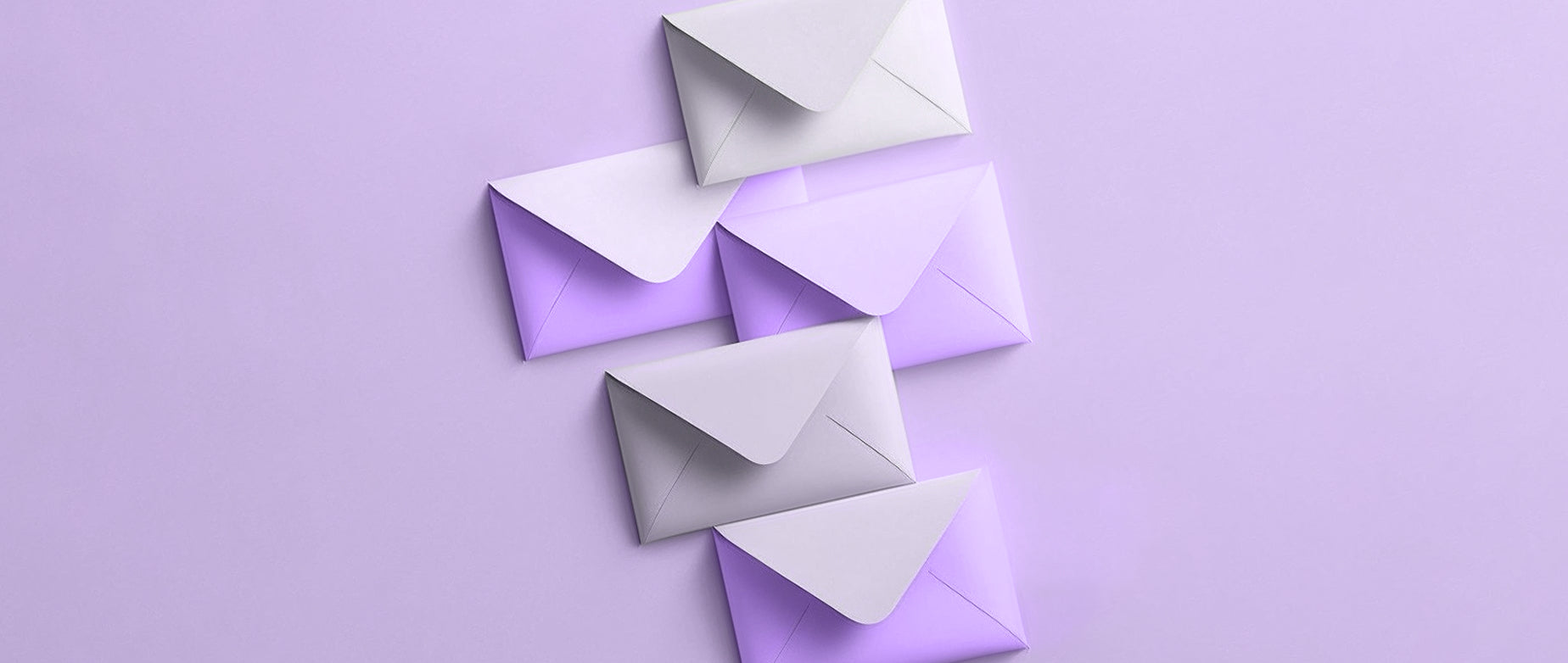 four envelopes that overlap and fall diagonally from left to right