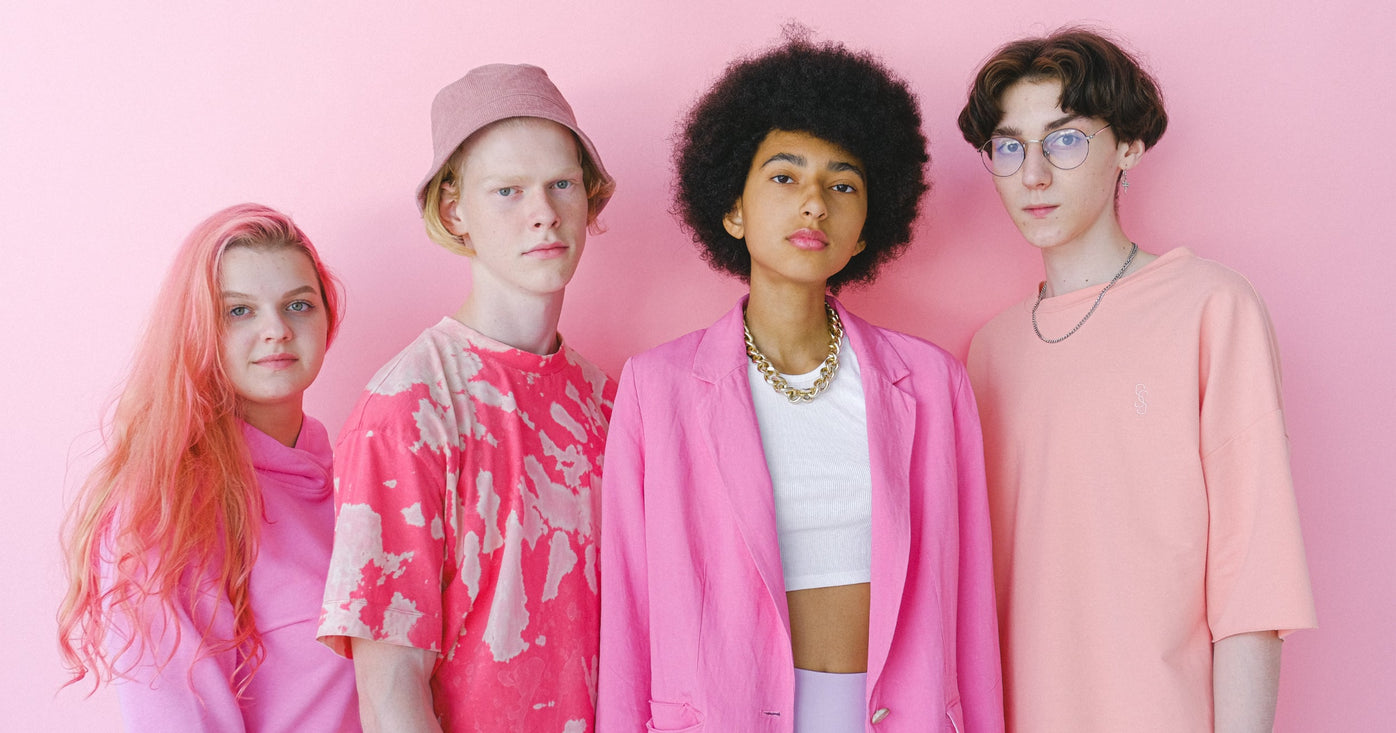 four young people wearing pink looking straight at the camera: intended audience