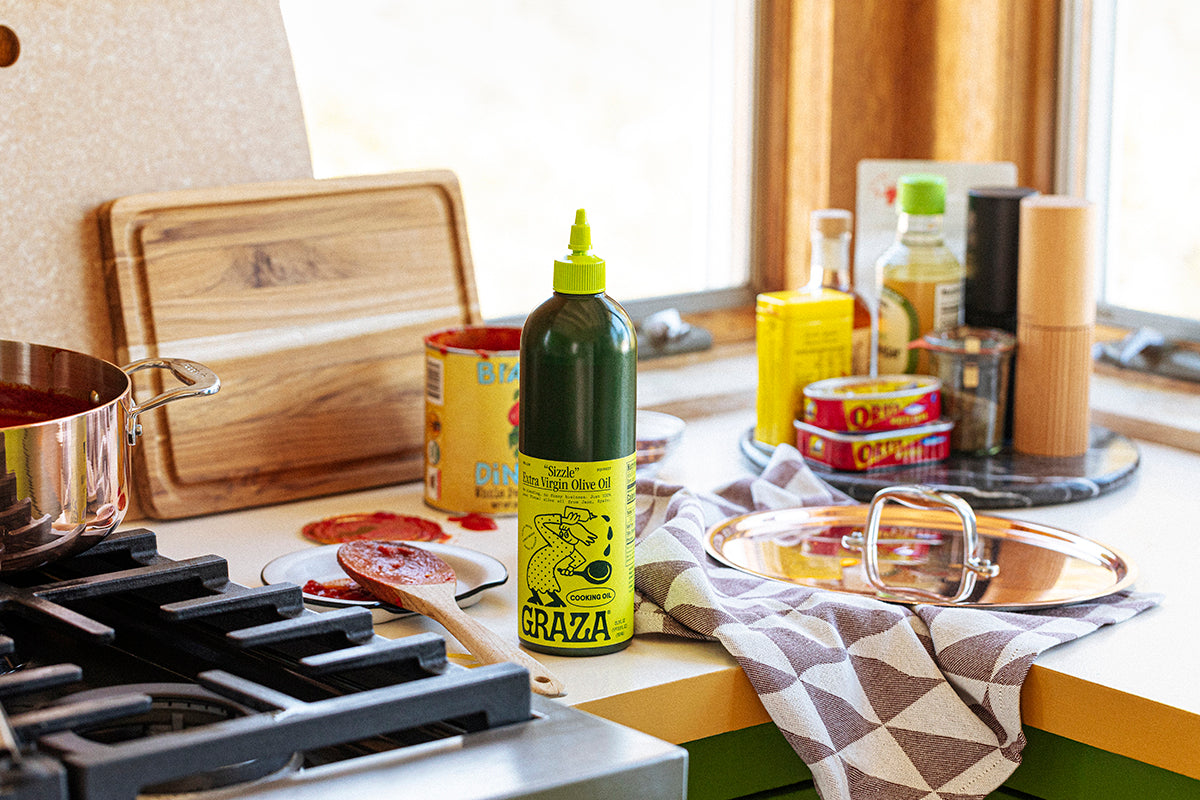 A bottle of Graza olive oil on a kitchen countertop