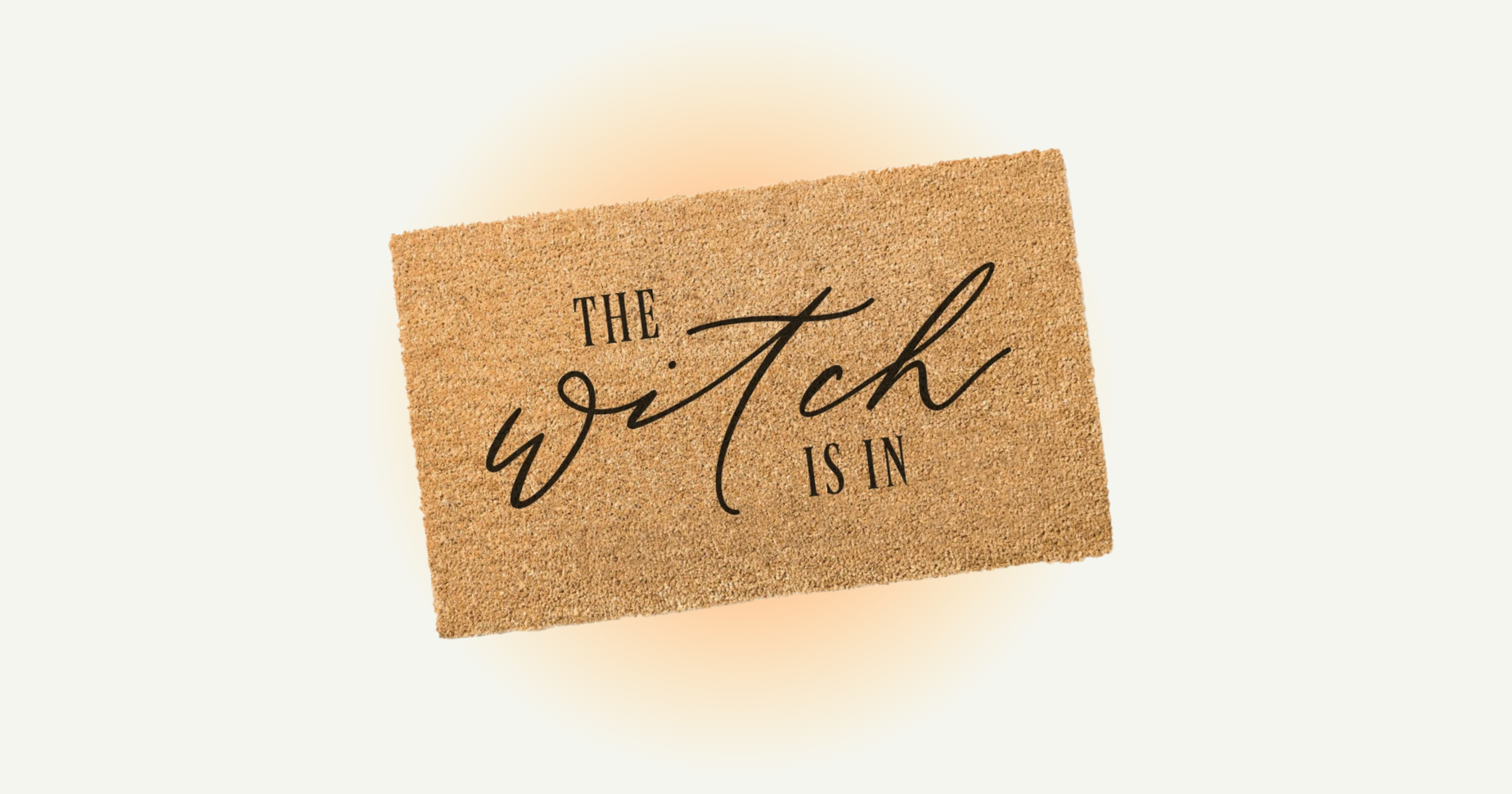 Welcome floor mat with "The Witch Is In" written on it