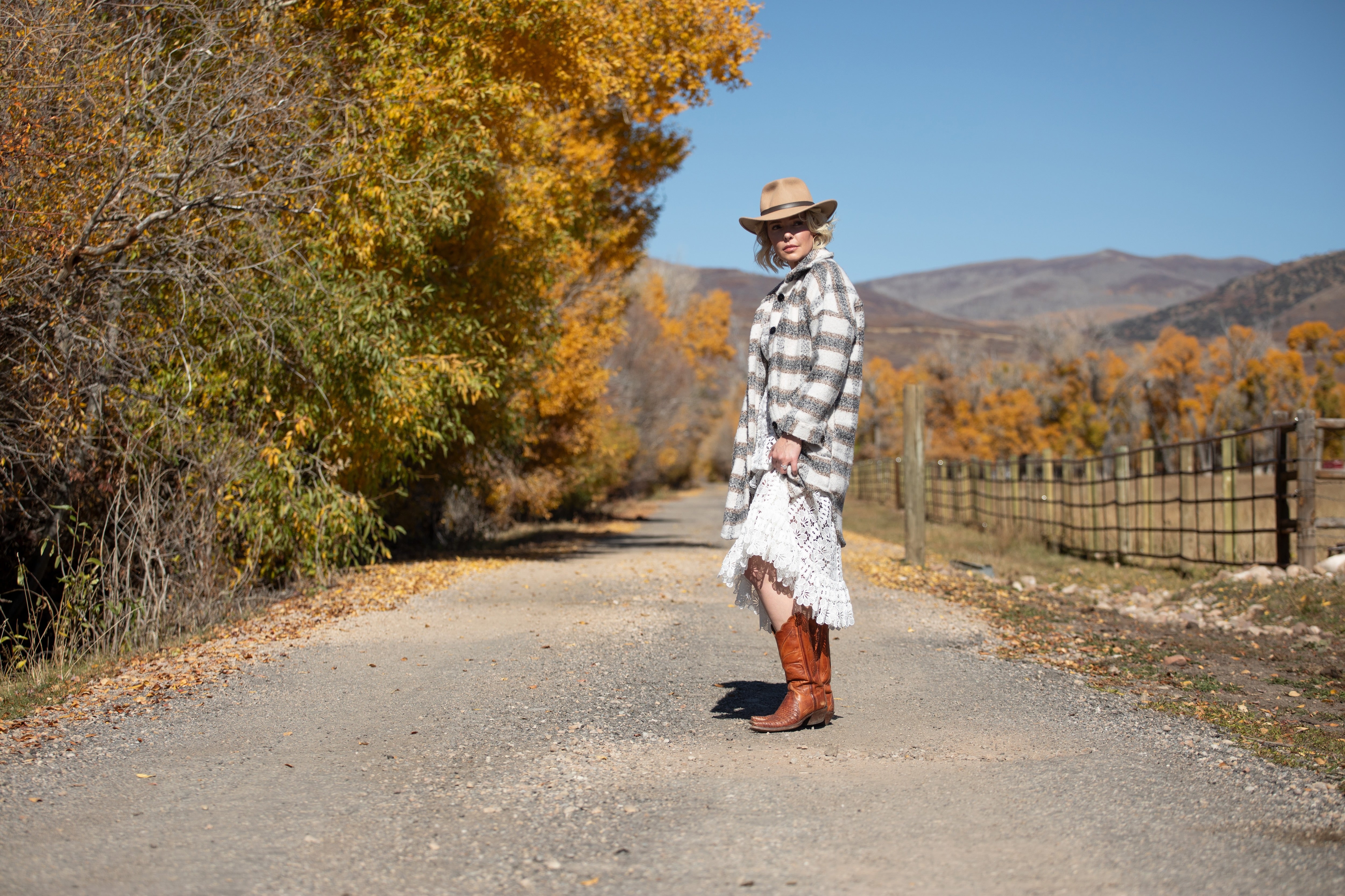 Katherine Heigl standing on a gravel road.
