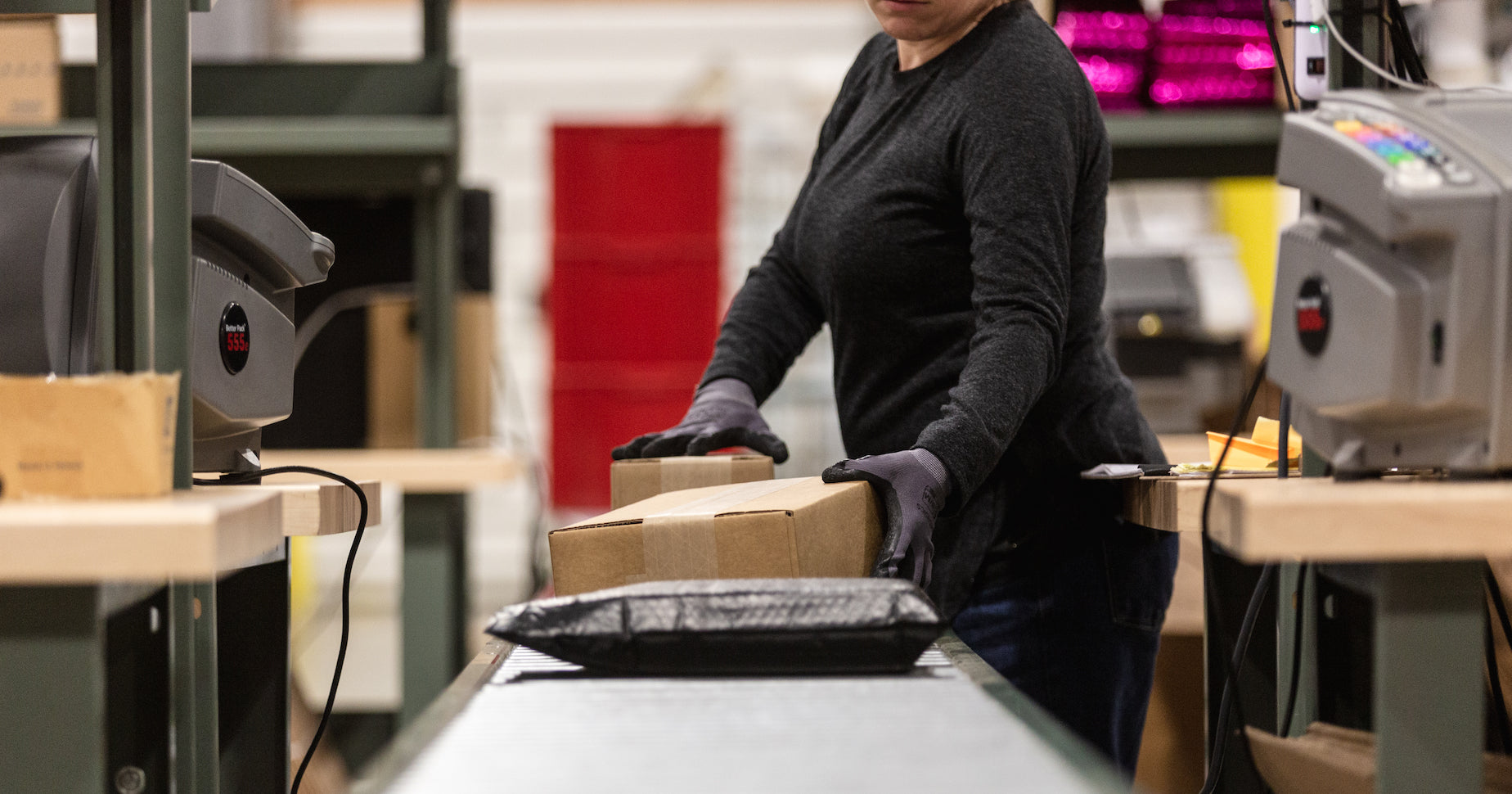 A fulfillment specialist preparing packages for delivery. 