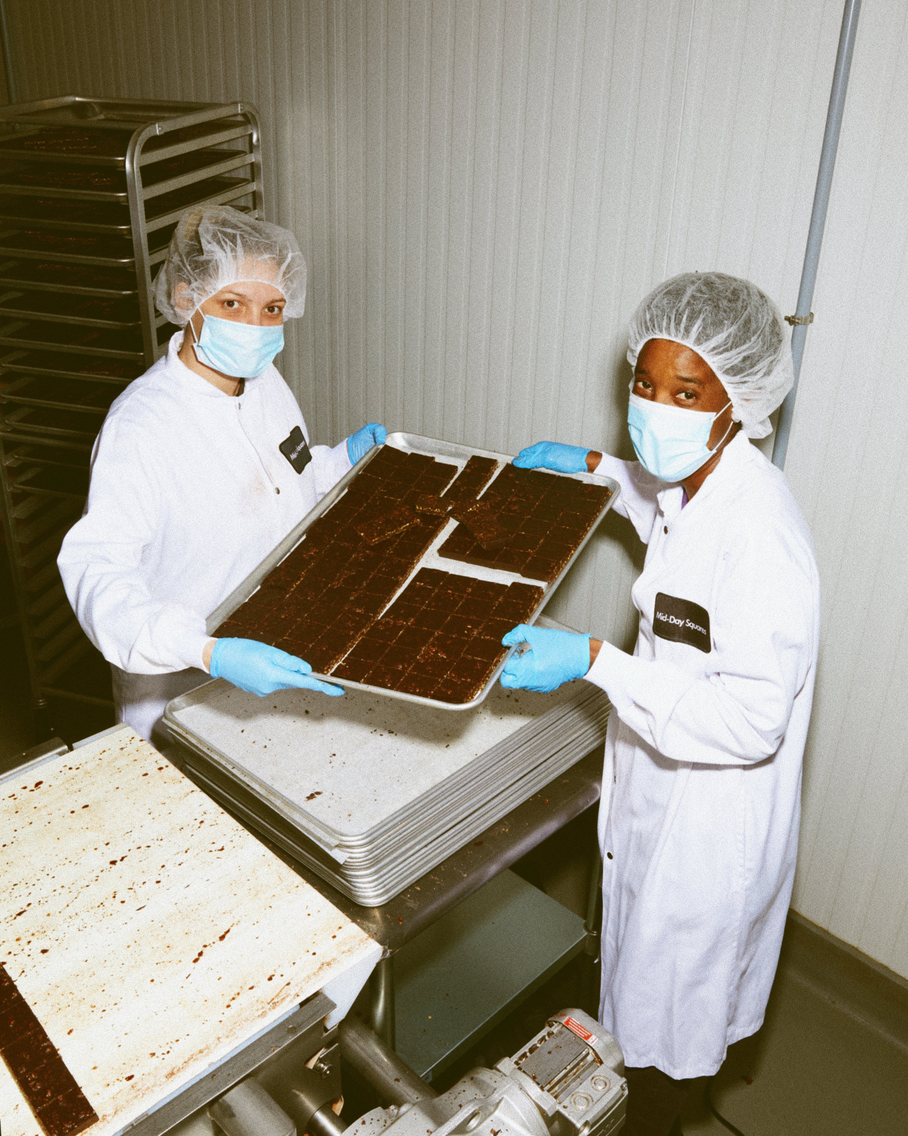 Two Mid-Day Squares employees making a batch of chocolate.