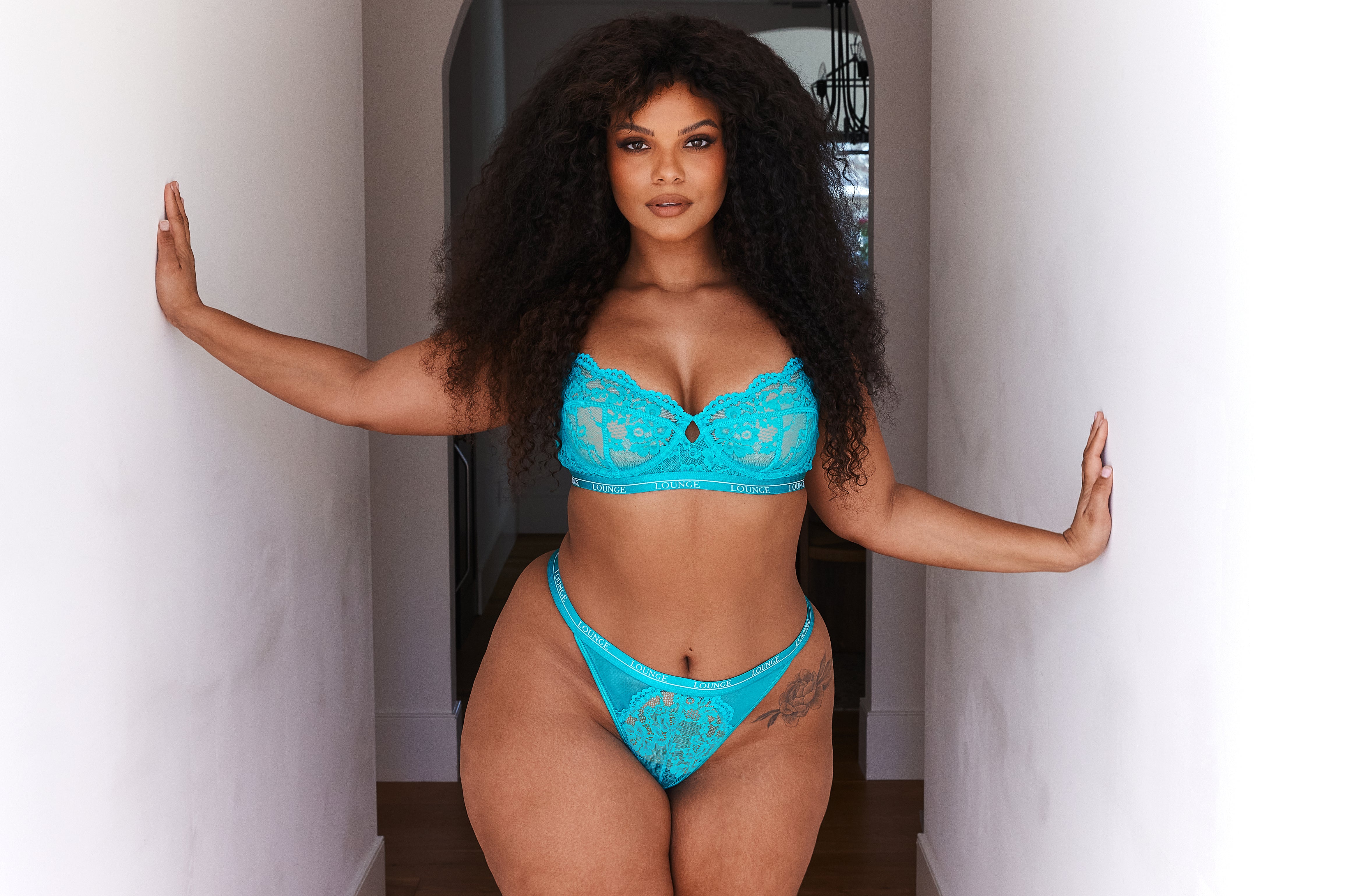 A model in a bright turquoise intimate set from Lounge Underwear. 