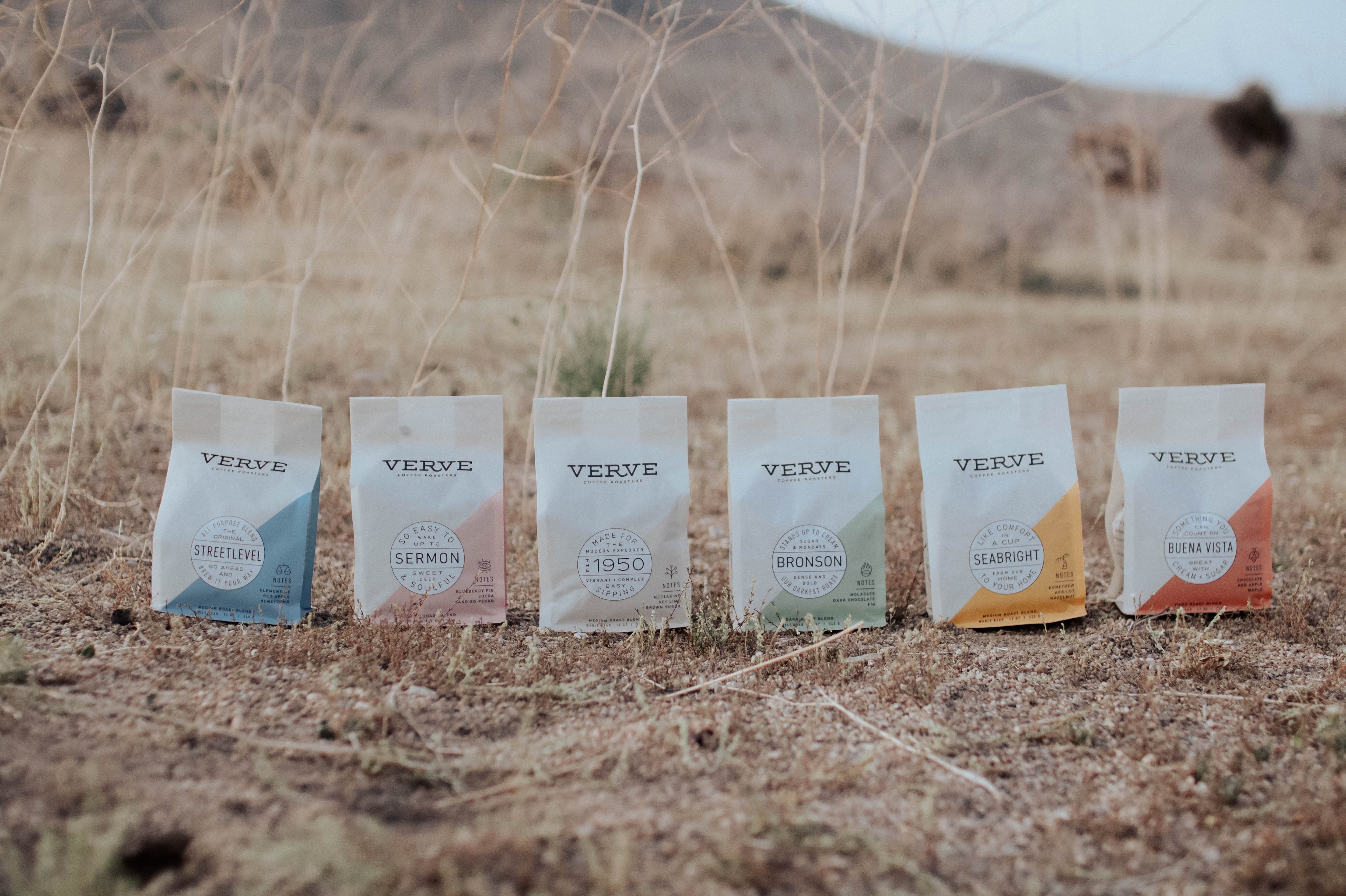 All of the Verve Coffee bags lined up side-by-side, sitting in an empty field. 