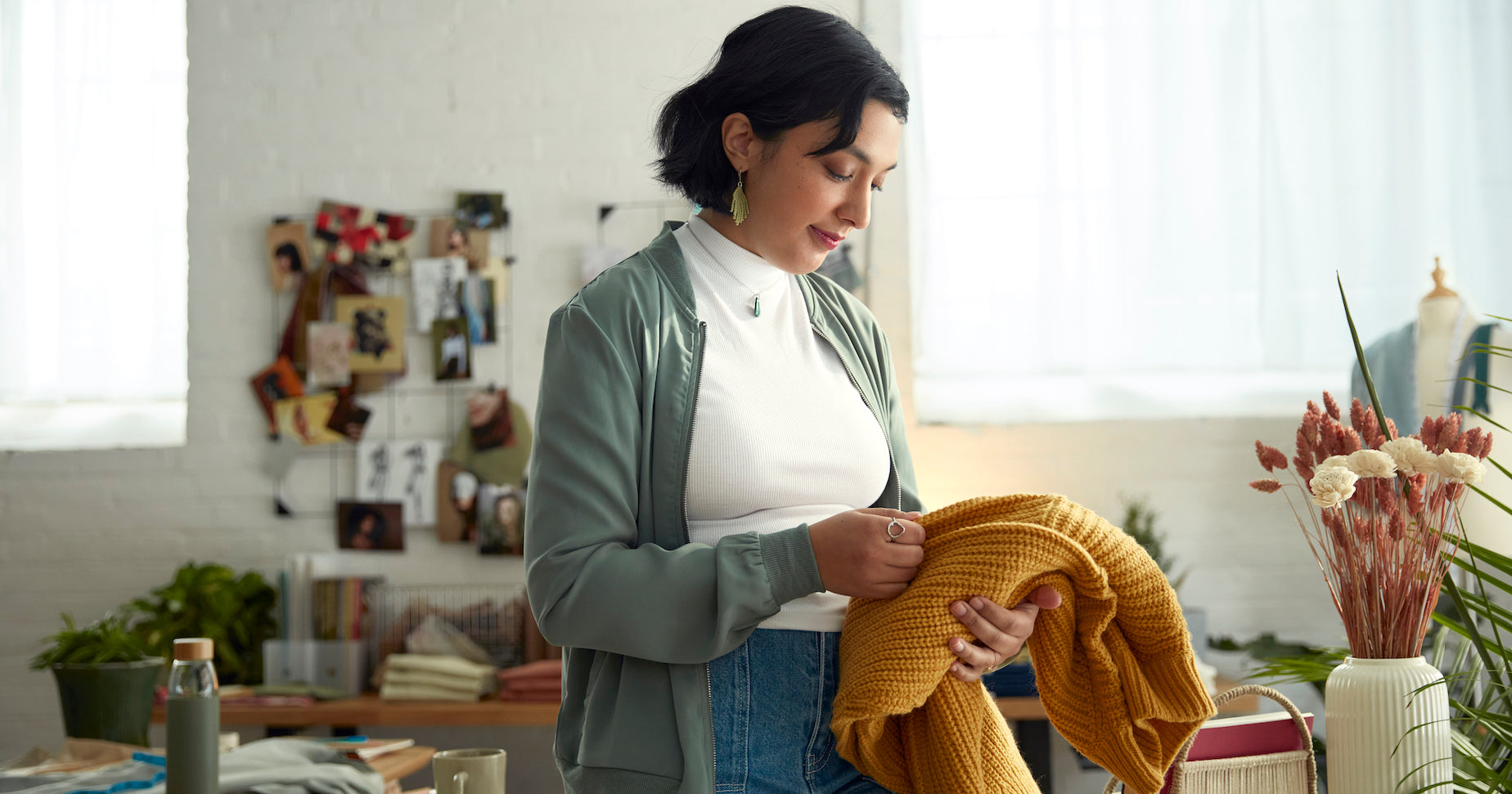 An apparel merchant checking a piece of her inventory.