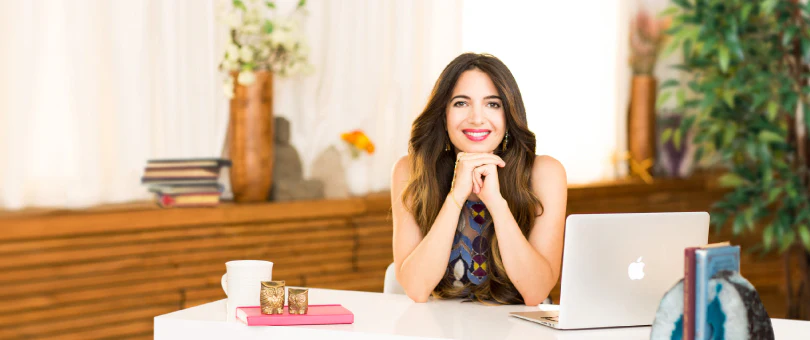 Marie Forleo sitting at her desk