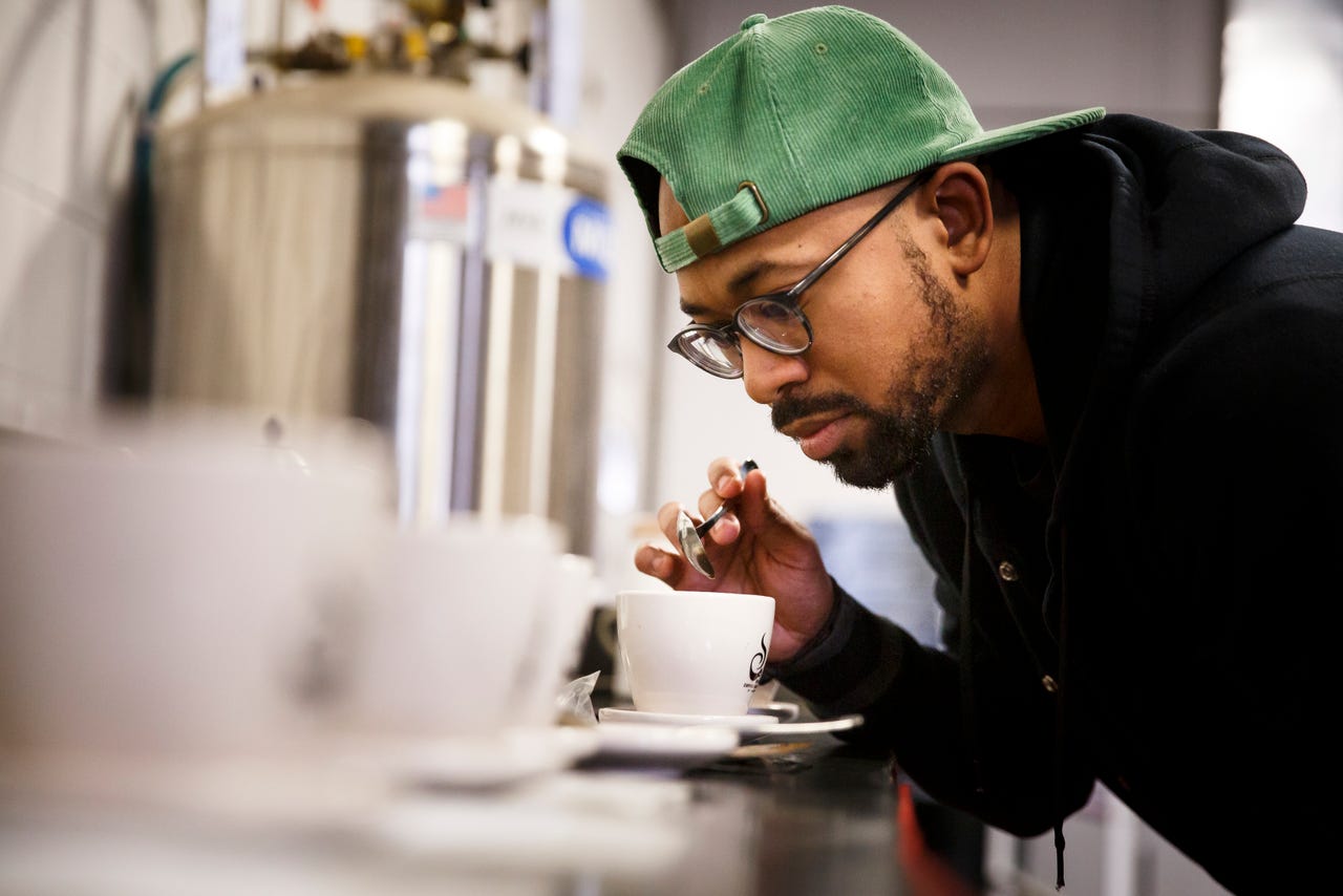 Pernell Cezar sampling coffee. 