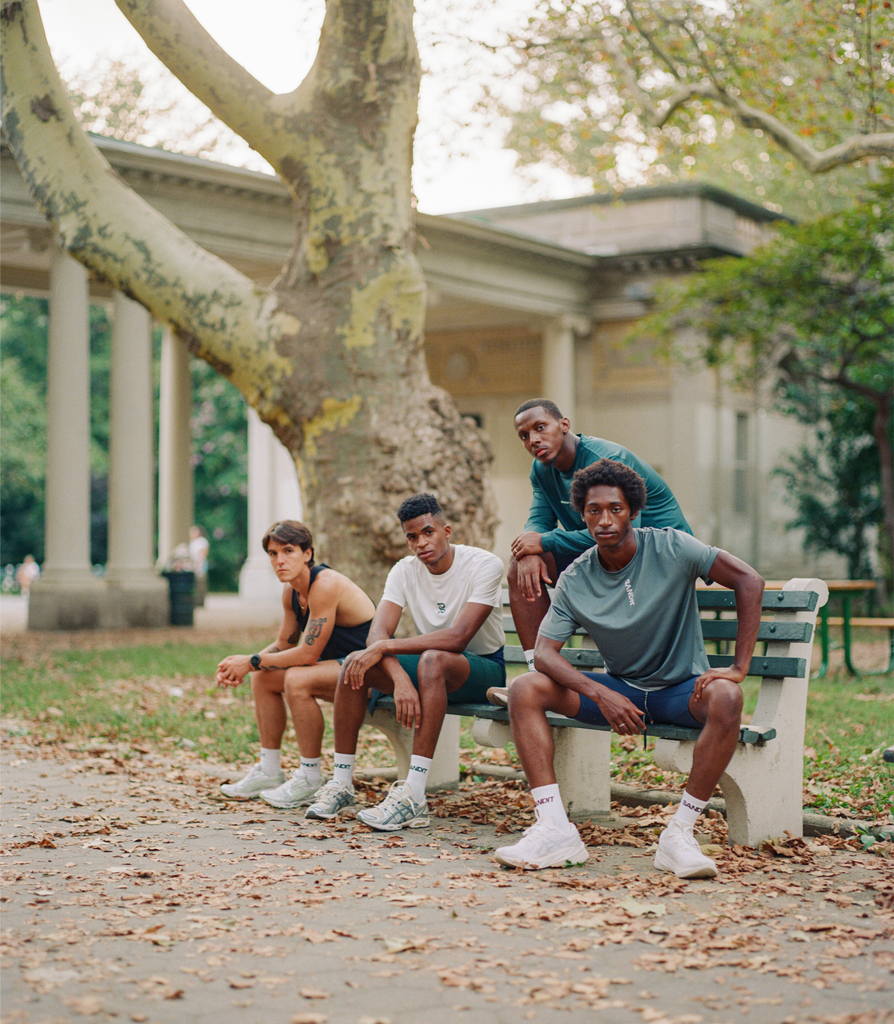 Four runners sitting on a park bench in Bandit clothing