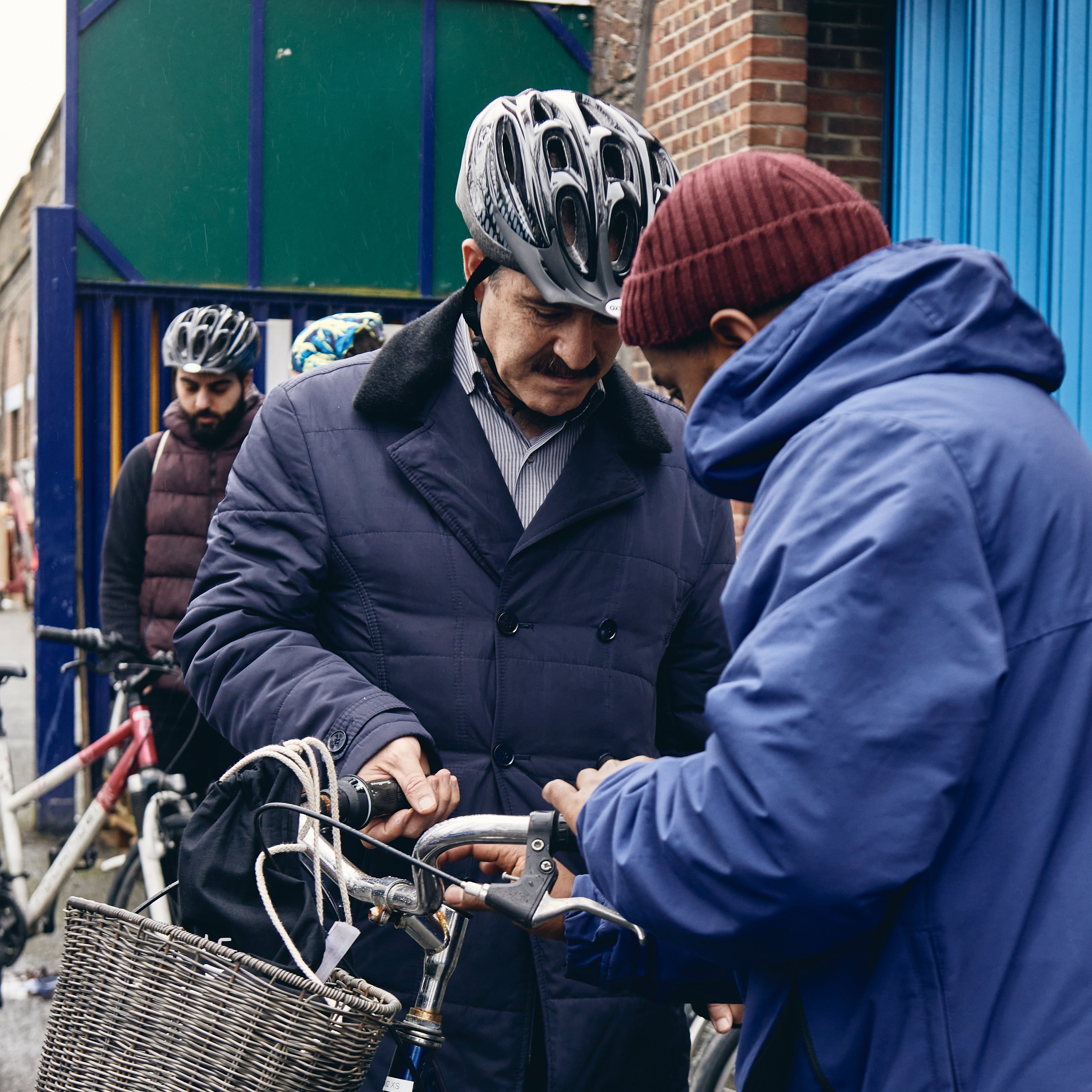  A few cyclists gather outside of The Bike Project for an event. 