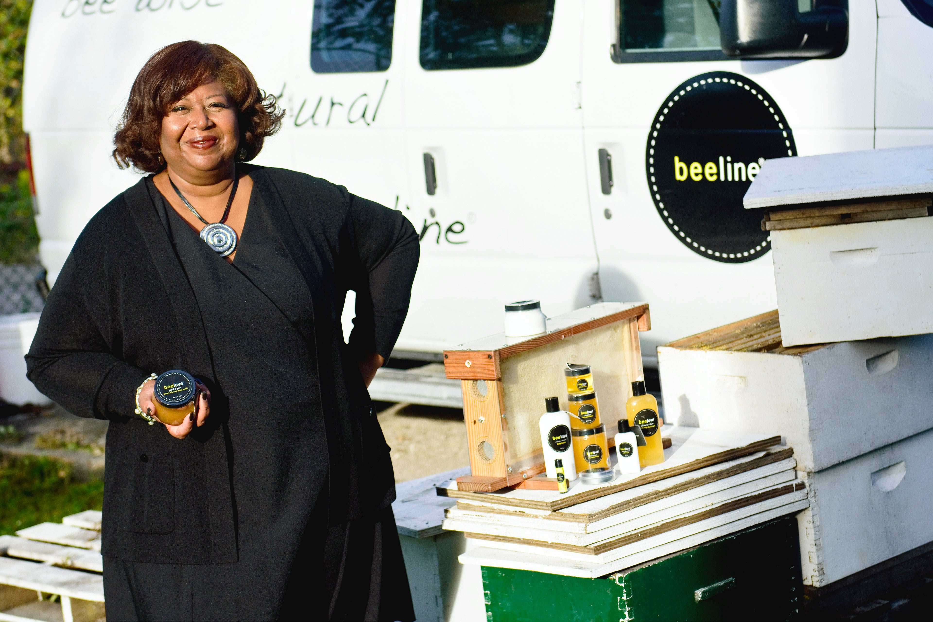 Brenda Palms Barber, founder of  Sweet Beginnings poses with some beelove products. 