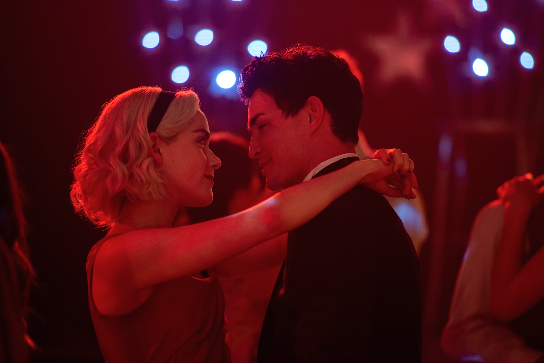 Sabrina Spellman slow dances with Nick at a Valentine’s Day dance in a scene from Chilling Adventures of Sabrina.