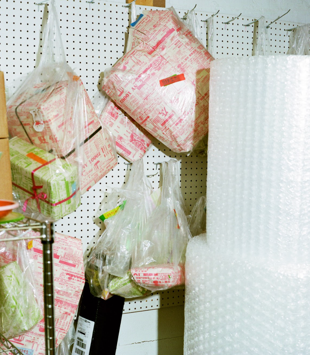 wrapped parcels handing in plastic bags against a peg board