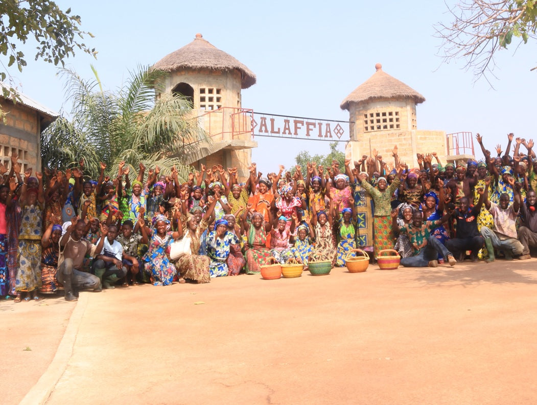 Team members of Alaffia at the gate of their cooperative. 