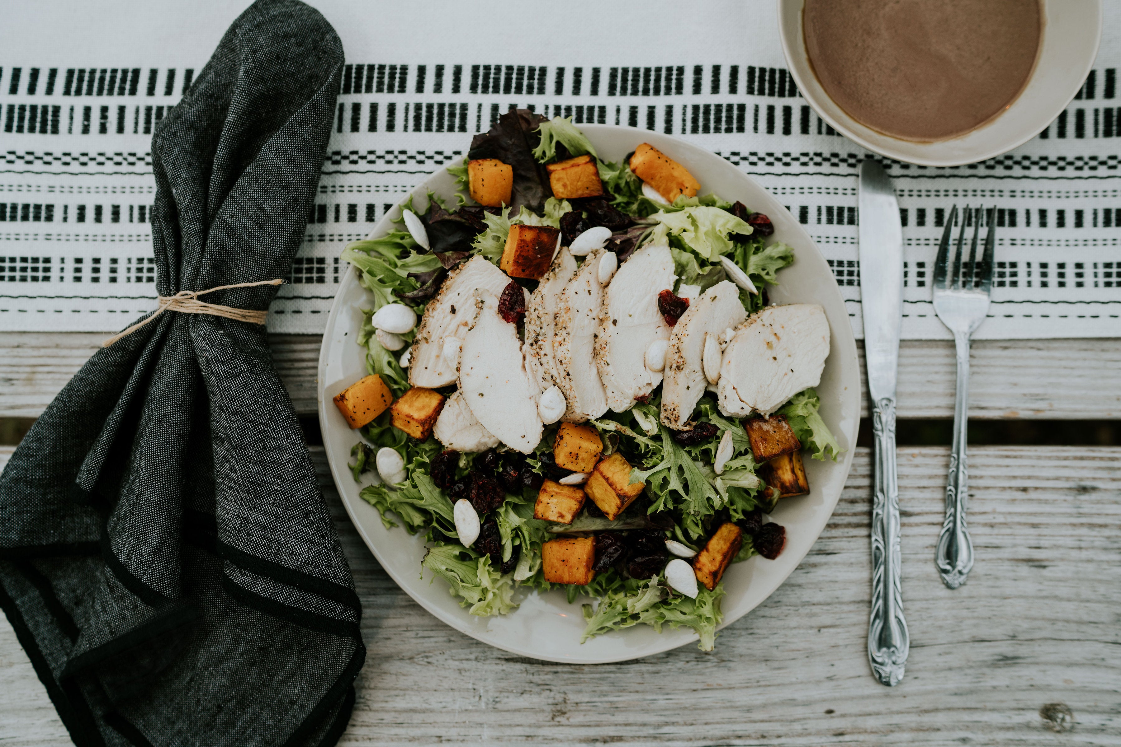 A meal consisting of chicken, sweat potatoes, and salad from Eat Well Nashville. 