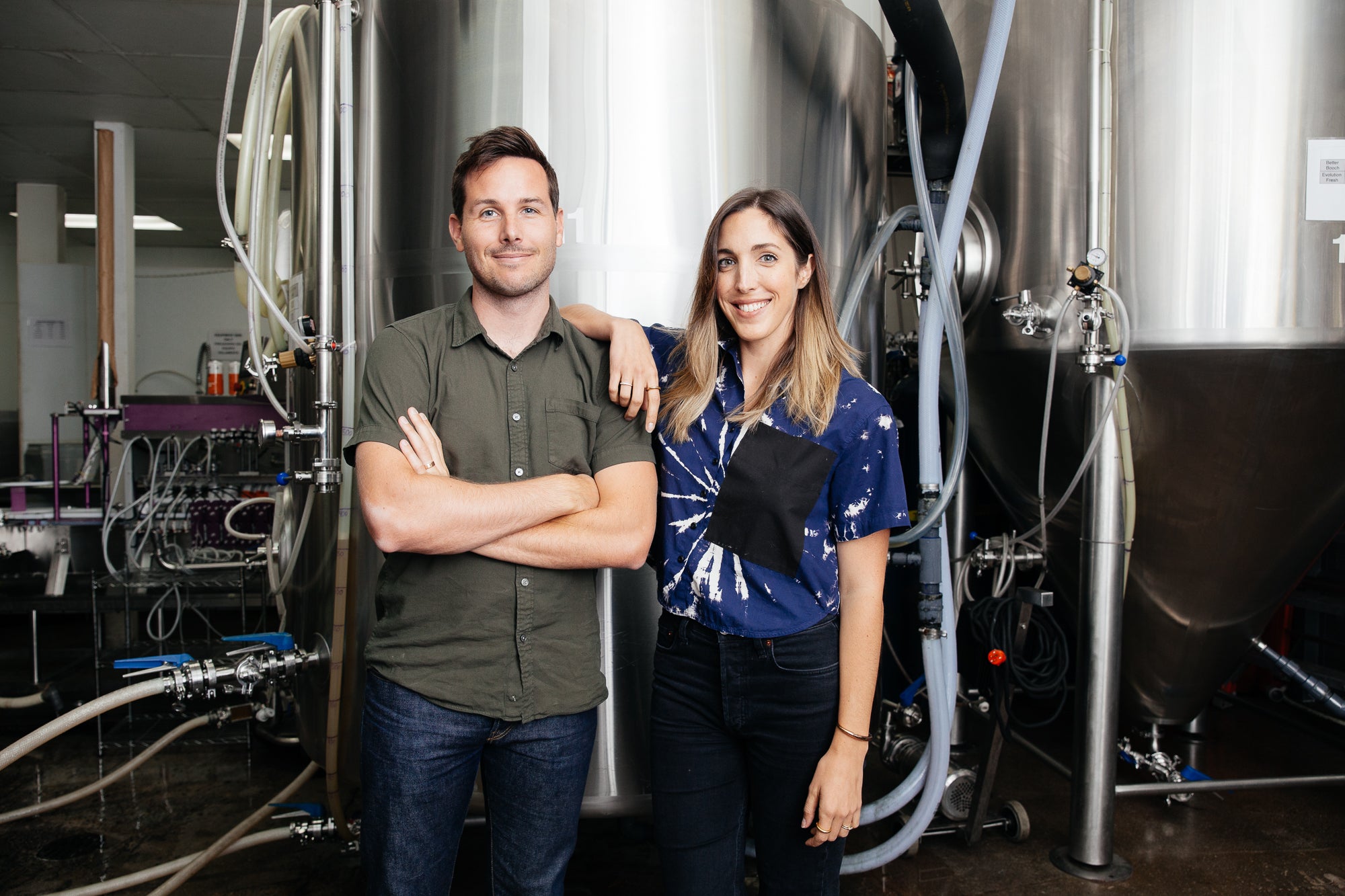 Better Booch co-founders Trey and Ashleigh Lockerbie in front of their kombucha brewing tanks. 