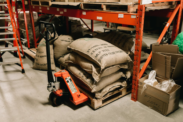 Four bags of Propeller Coffee Co. coffee stacked on a forklift