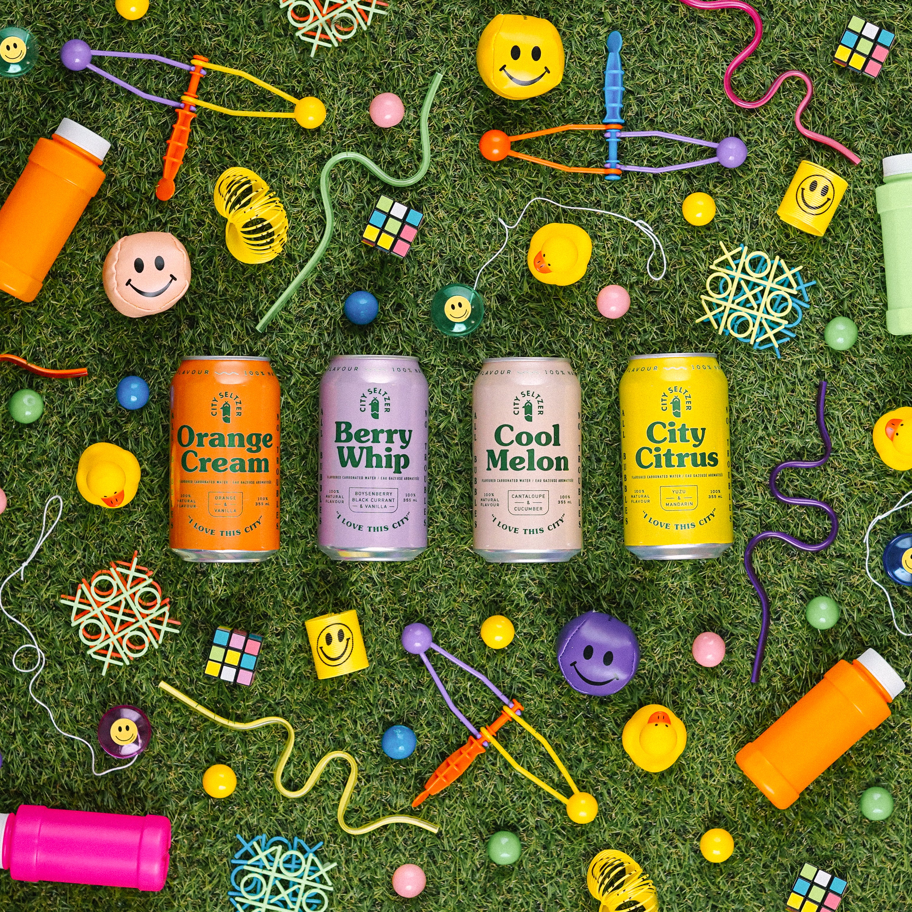 City Seltzer cans surrounded by toys
