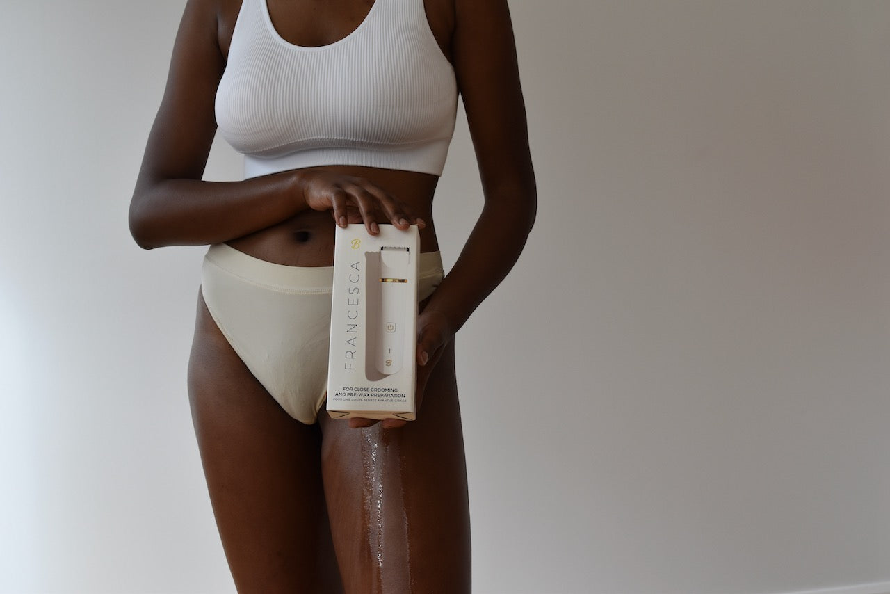 A model in white holding an electric trimmer made by Bushbalm.