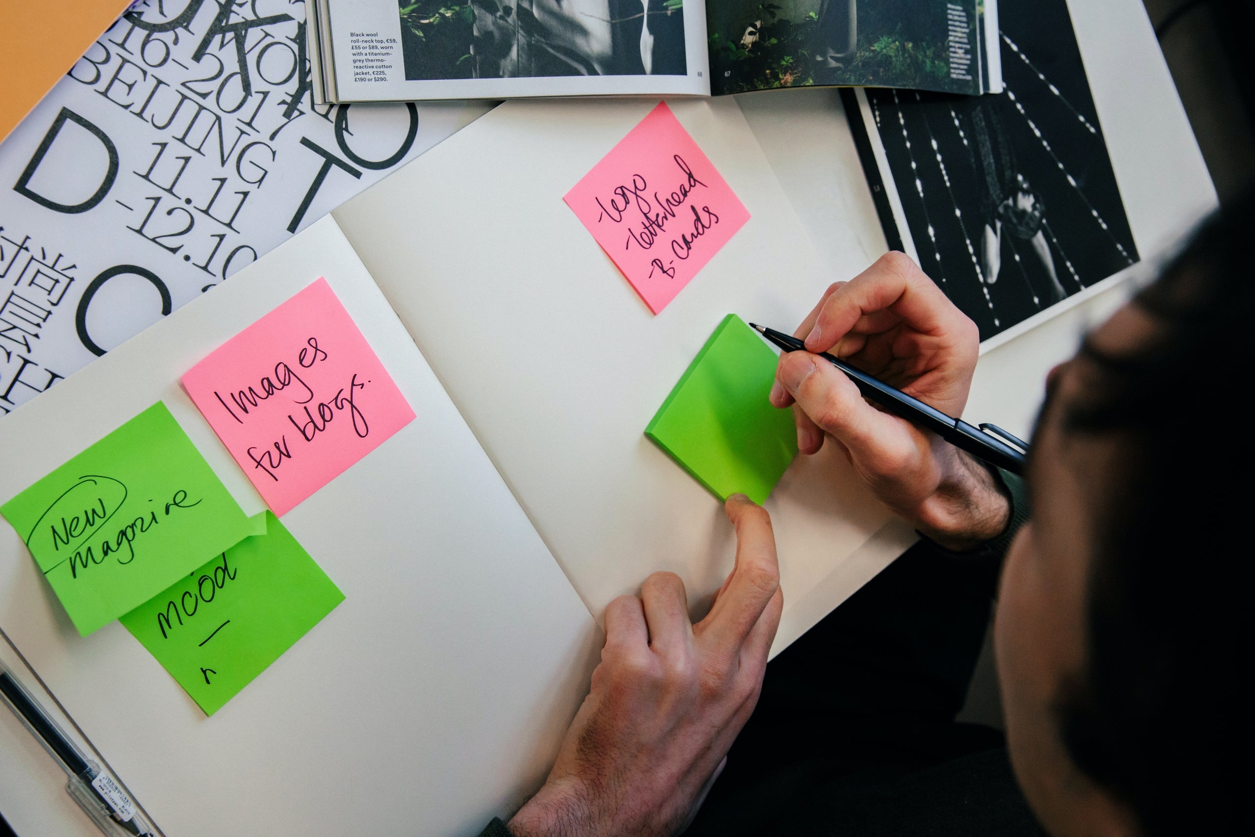 person-brainstorming-with-notebook-and-post-its