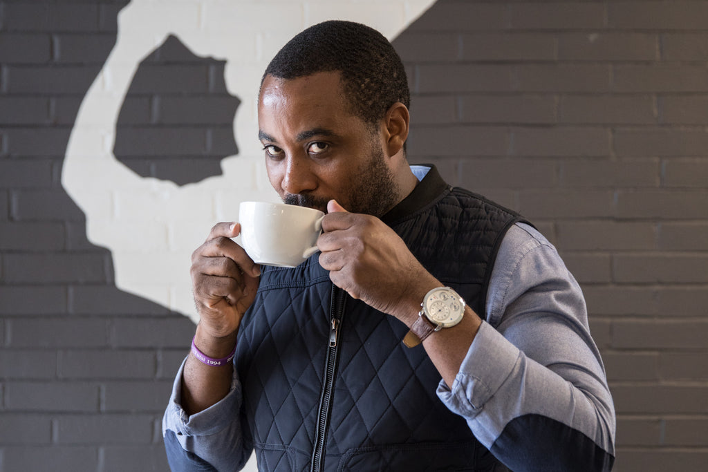 Portrait of Mike Mwenedata sipping cofffee at Rwanda Bean in Portland Oregon