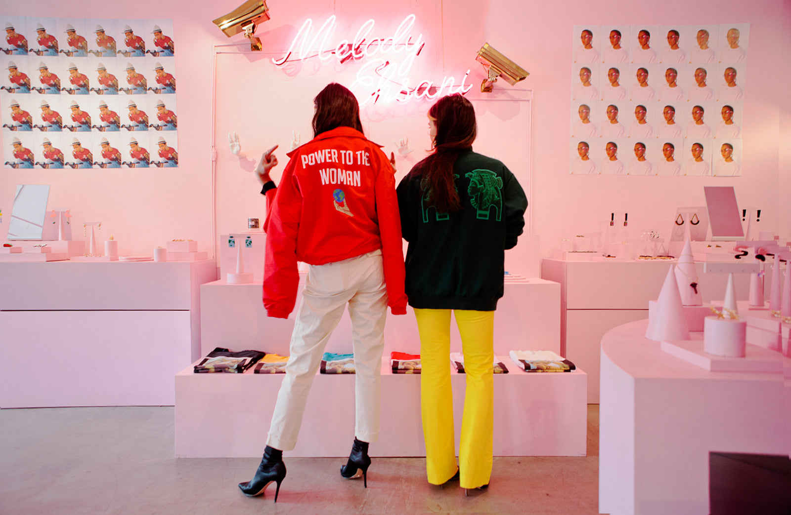 Shay Mitchell (left) displays the design on the back of her jacket, which reads "Power to The Women" and Melody Ehsani (right) displays the Egyptian Pharaohs design on the back of her jacket.