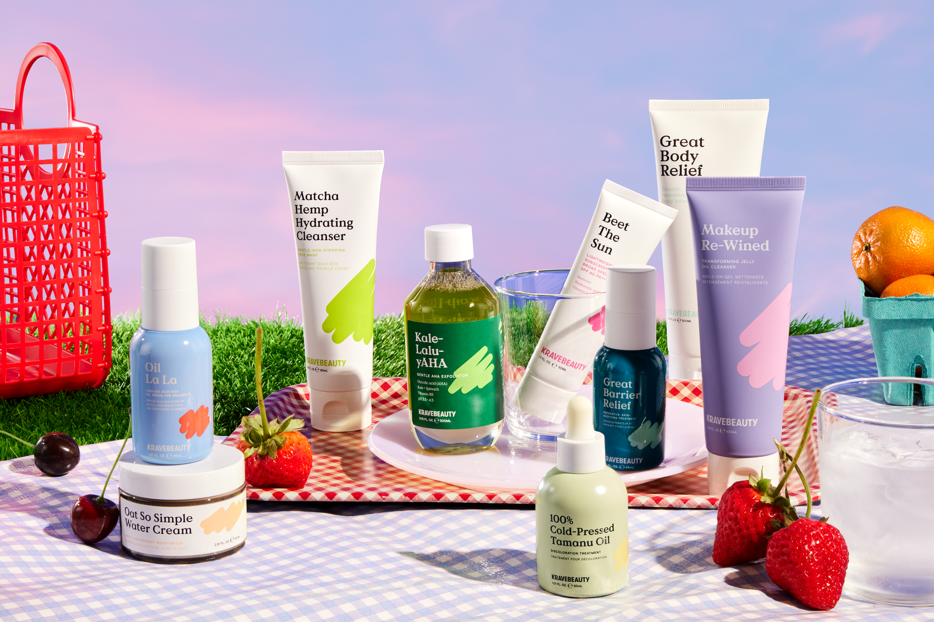 a picnic displaying all nine of the kravebeauty products. In order from left to right: oil la la, oat so simple water cream, matcha hemp hydrating cleanser, kale-lalu-yAHA, beet the sun, 100% cold-pressed tamanu oil, great barrier relief, great body relief, and makeup re-wined.
