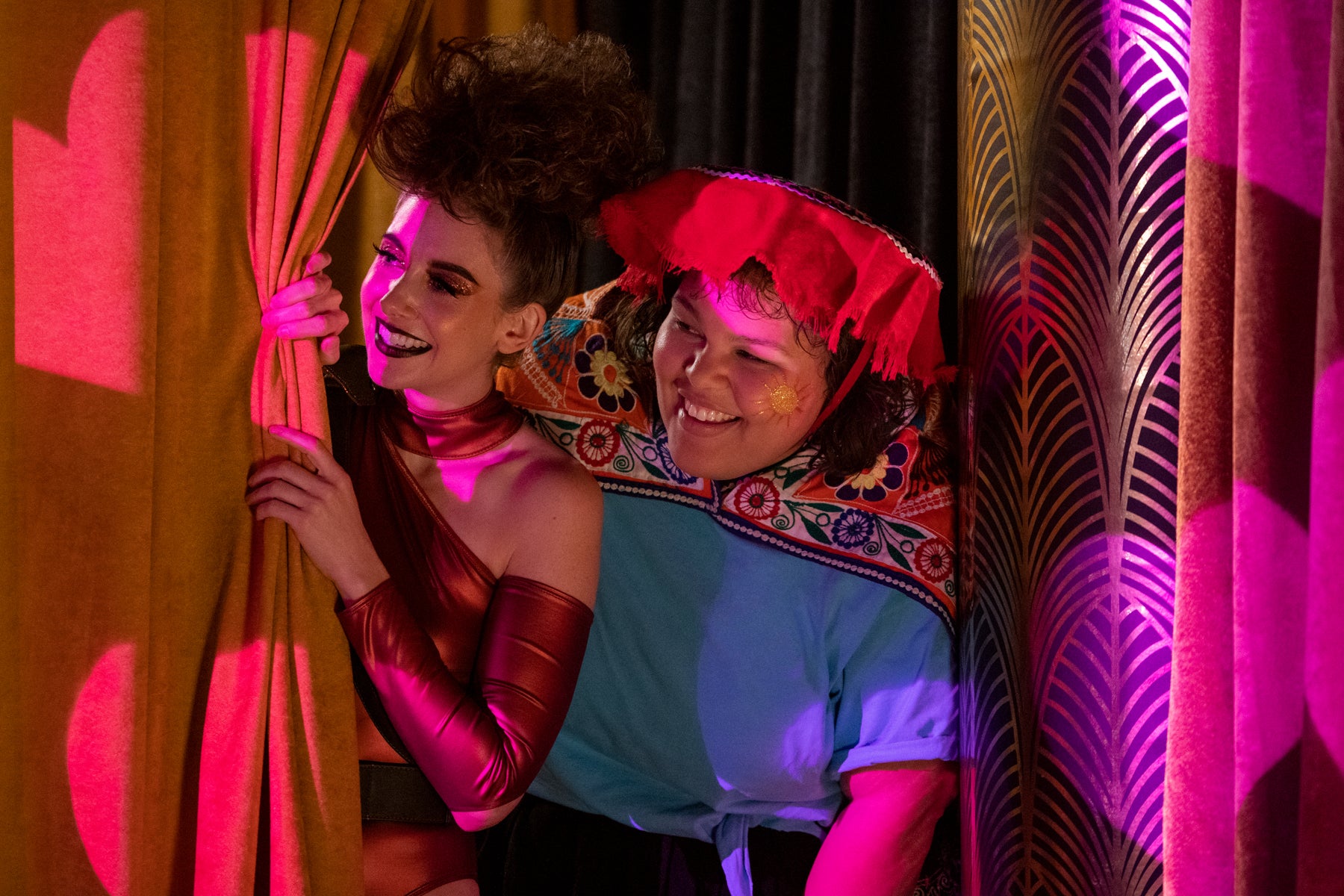 Zoya the Destroya and Machu Picchu peer out from behind a curtain during a performance of GLOW in Las Vegas, during Season 3. 