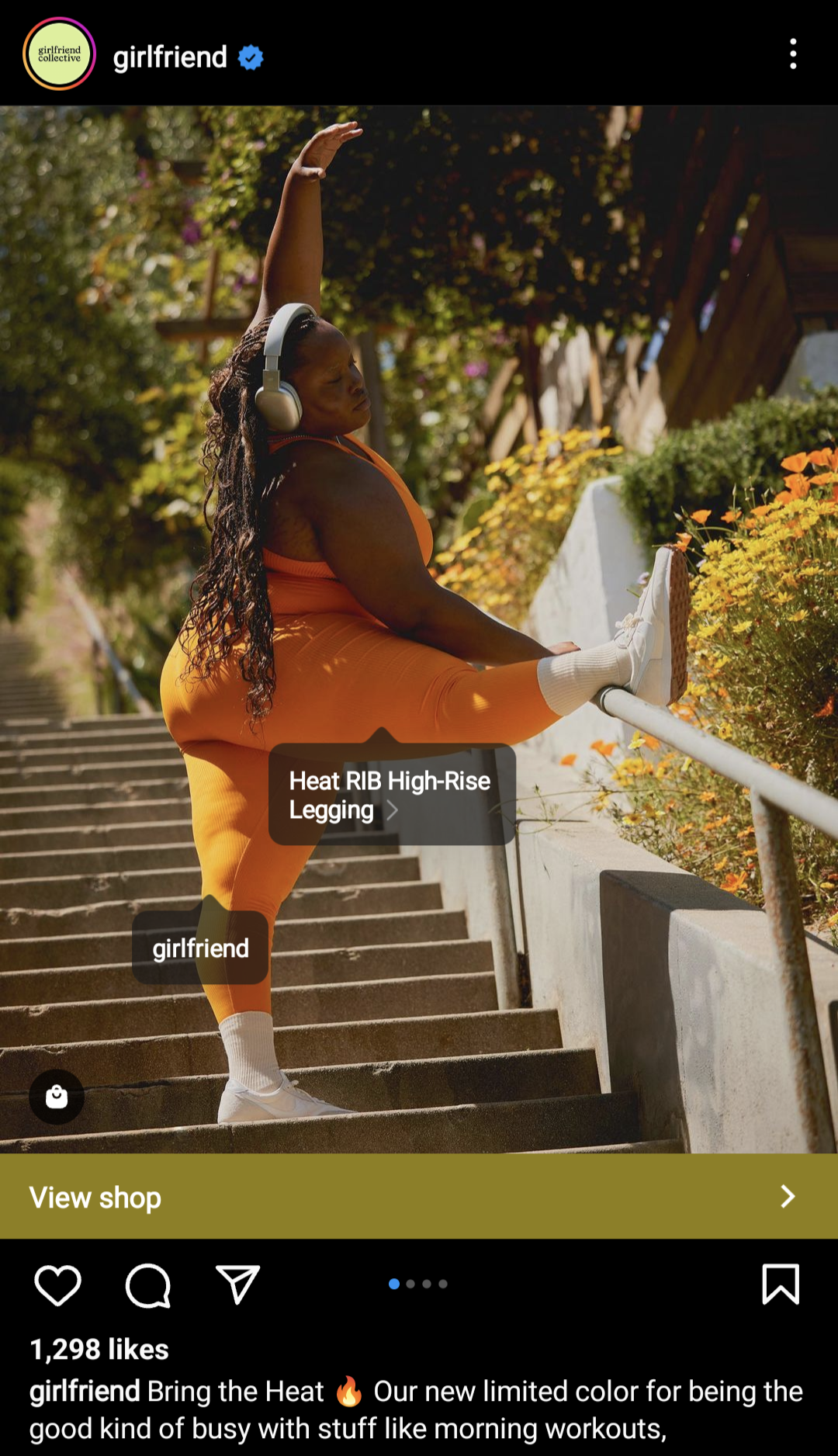 Girlfriend Collective instagram post of woman in athletic wear stretching wearing headphones.