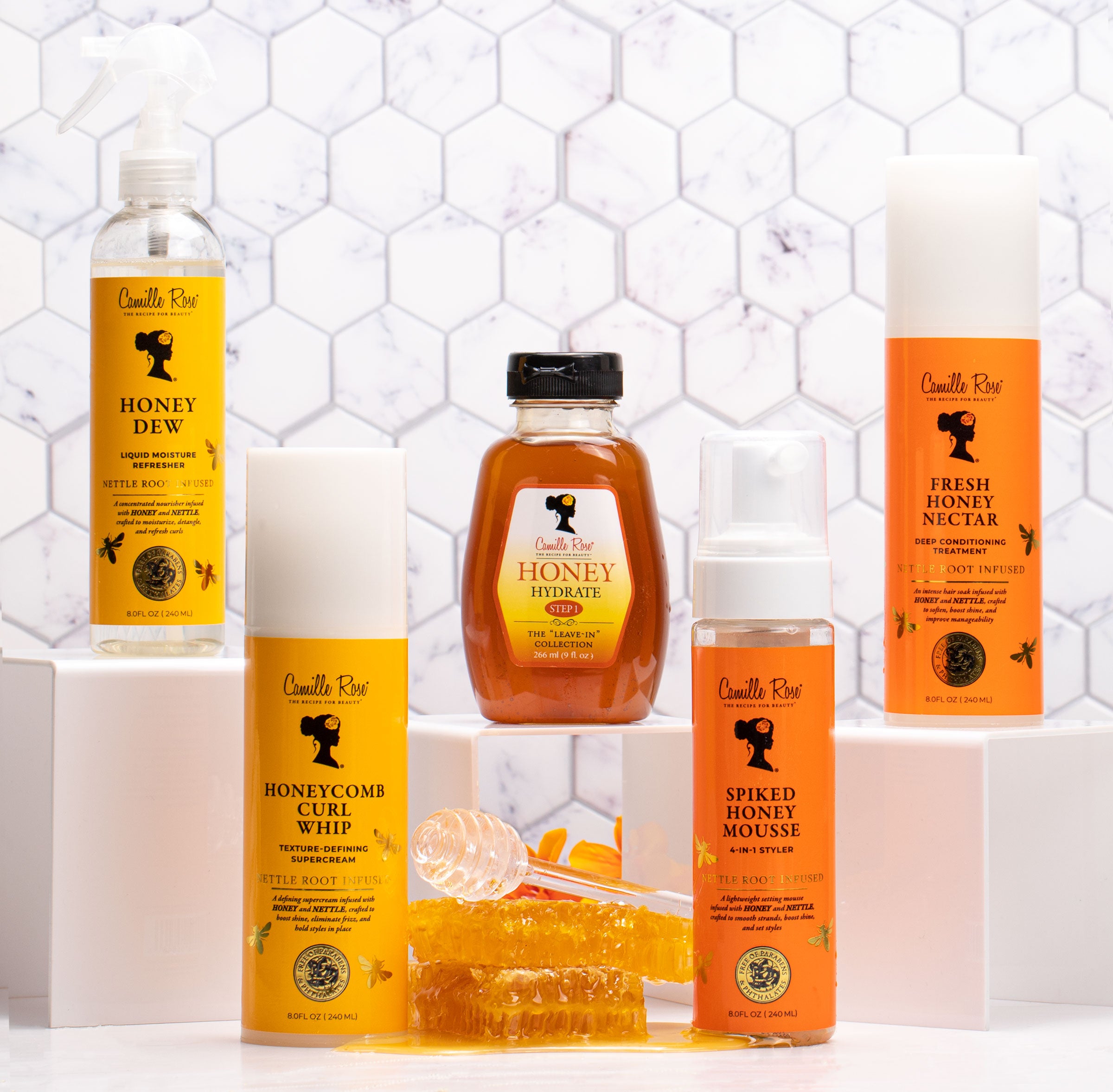 The honey collection of Camille Rose products backdropped by a tiled background. 