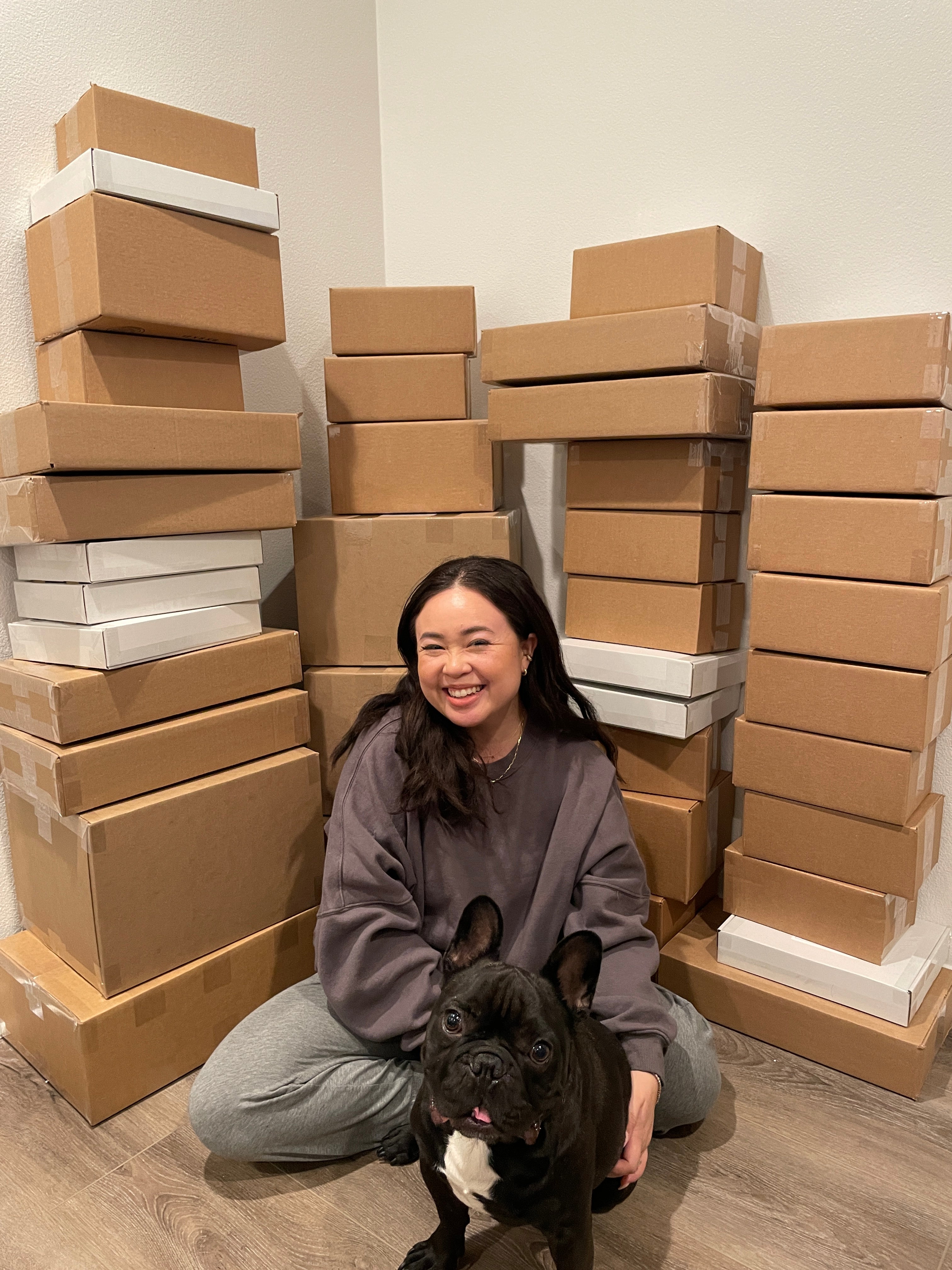 Fashionica founder Nica Yusay sits in front of her packed handbags before shipping them off to customers. 