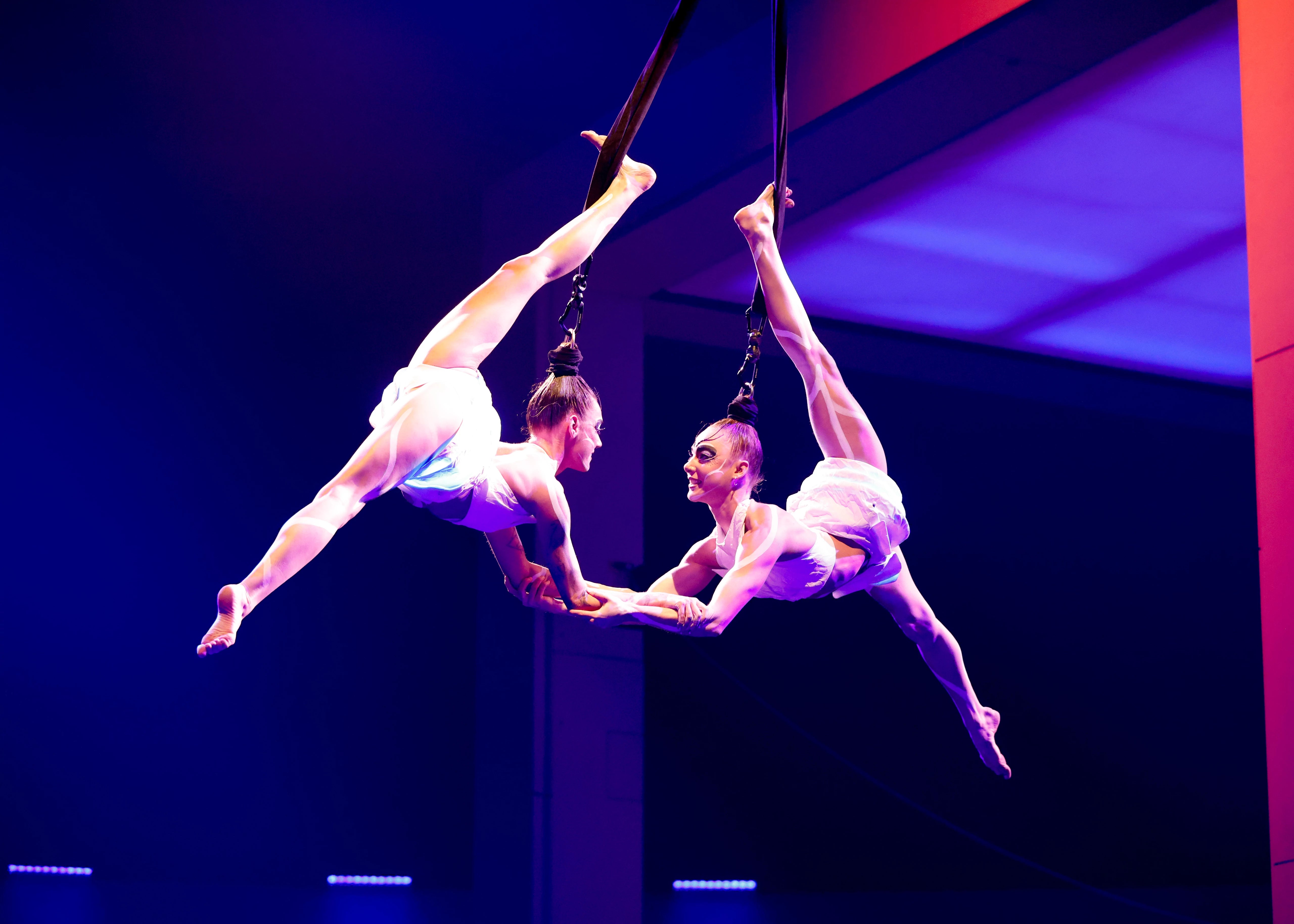 Two performers dispensed from the ceiling by their hair perform in the latest Cirque du Soleil show, ECHO.