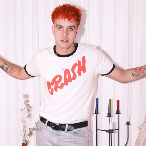 Man with red hair wearing a t-shirt that says “Crash”