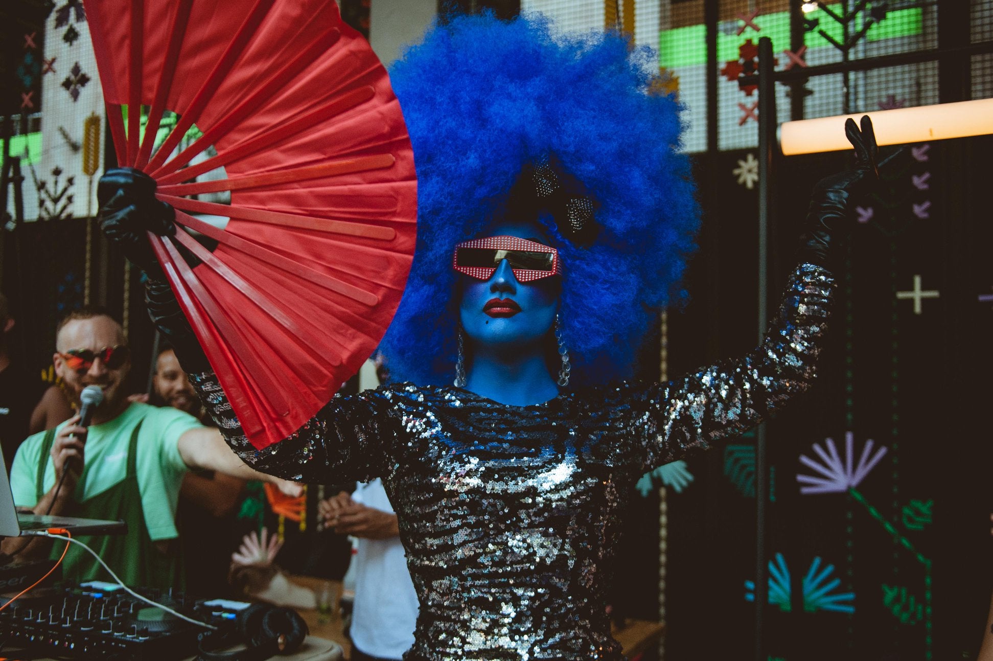 Drag queen Mango performing in blue dress and blue makeup