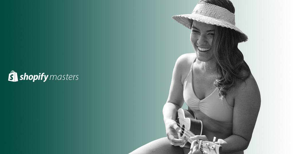 Founder of Fused Hawaii, Roxelle Cho in one of her own bikinis playing a ukulele.