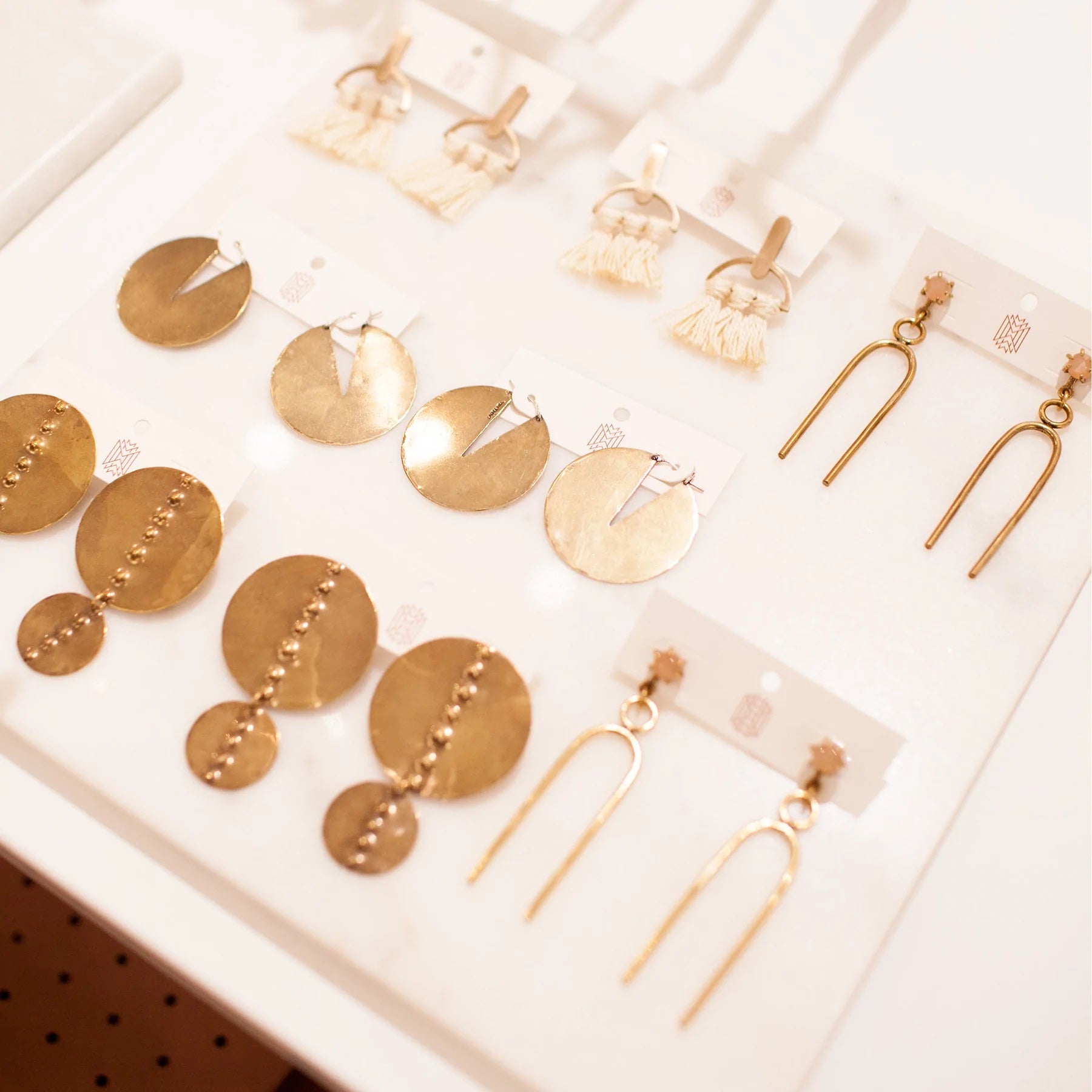 Merchandized gold jewelry lays arranged on a table