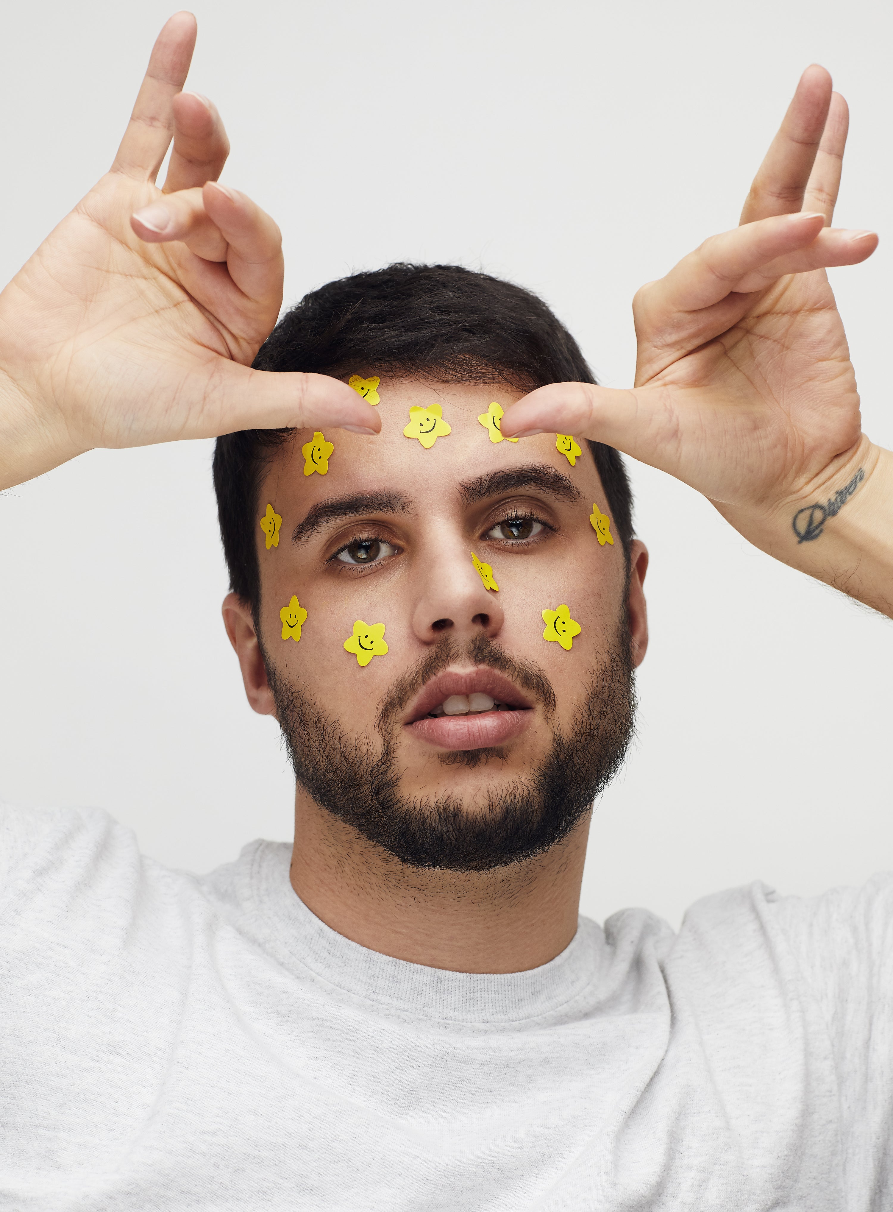 One of Mid-Day Squares’ co-founders, Nick Saltarelli, with smiley face stickers on his face. 