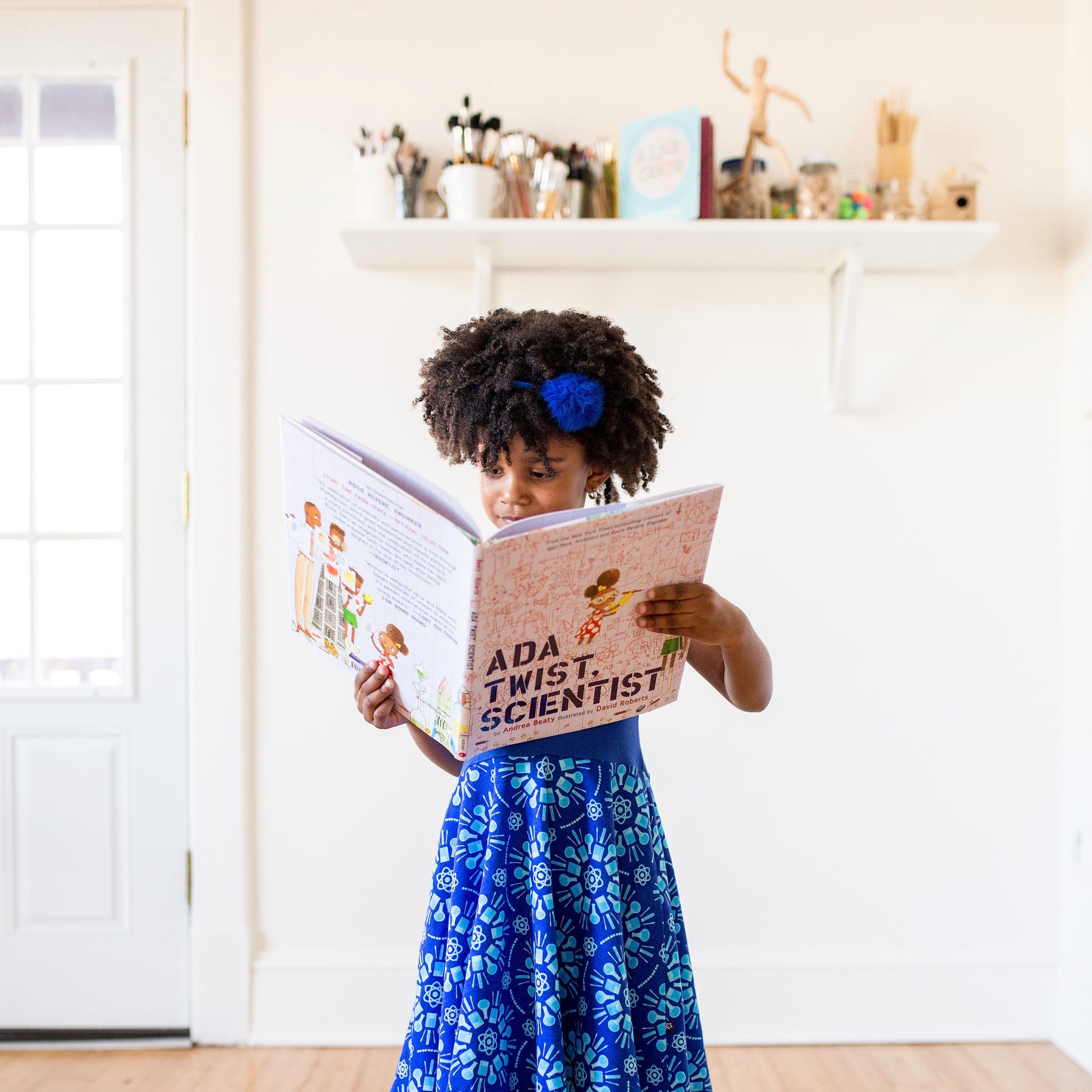 Girl models a blue dress from Princess Awesome.