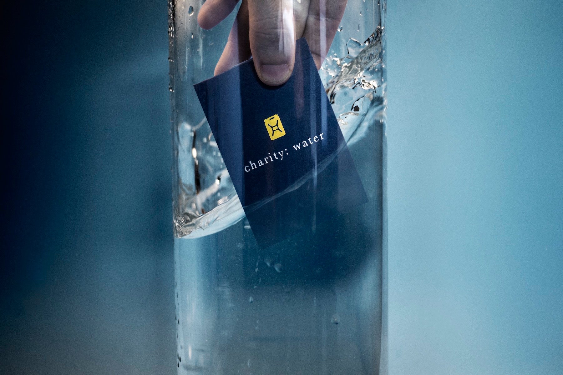 Photograph of a playing card being submerged in water. This card deck was made to raise money for clean water operations in Sudan, Ethiopia, Uganda, and Sierra Leone.