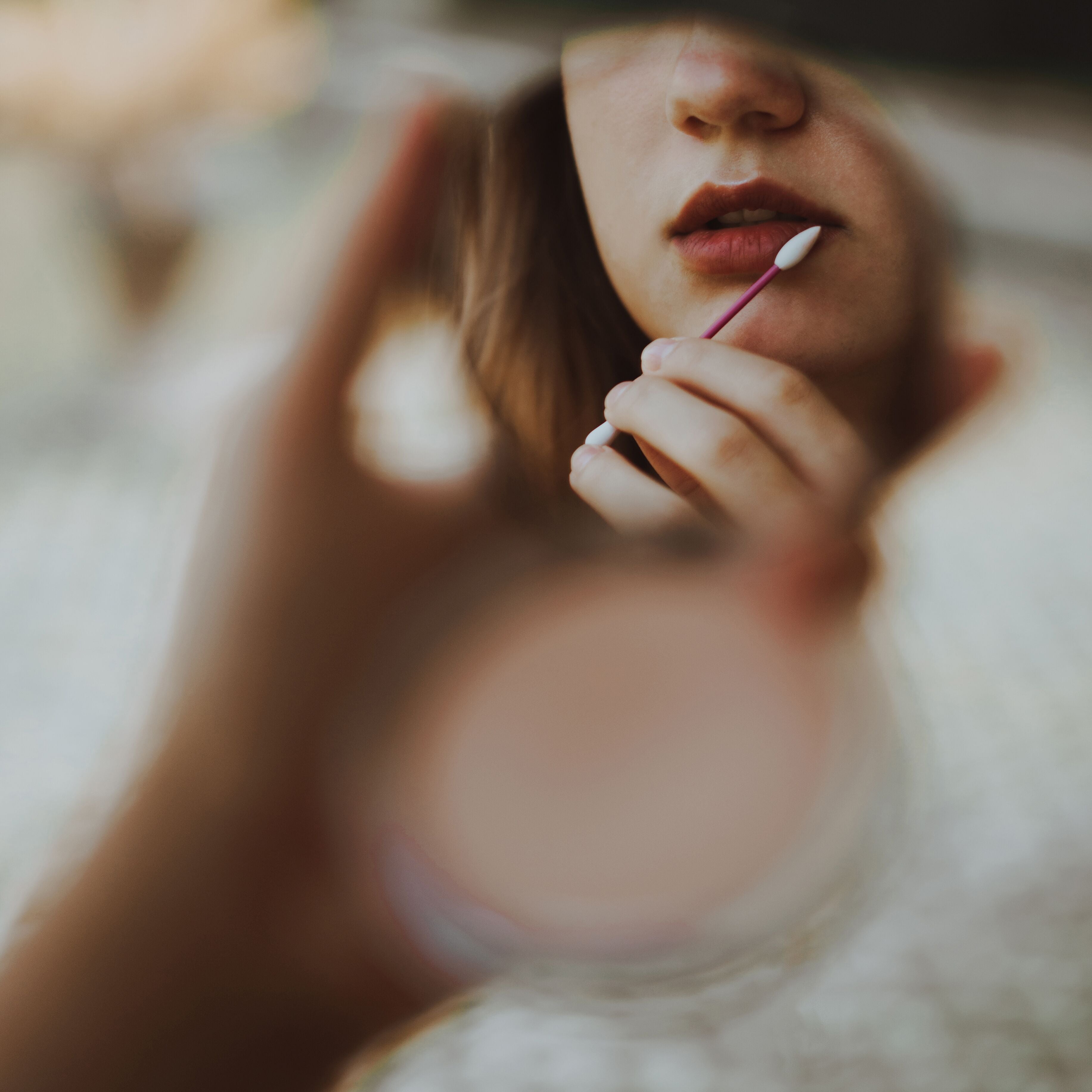 A model uses a LastSwab on a makeup application for her lips. 