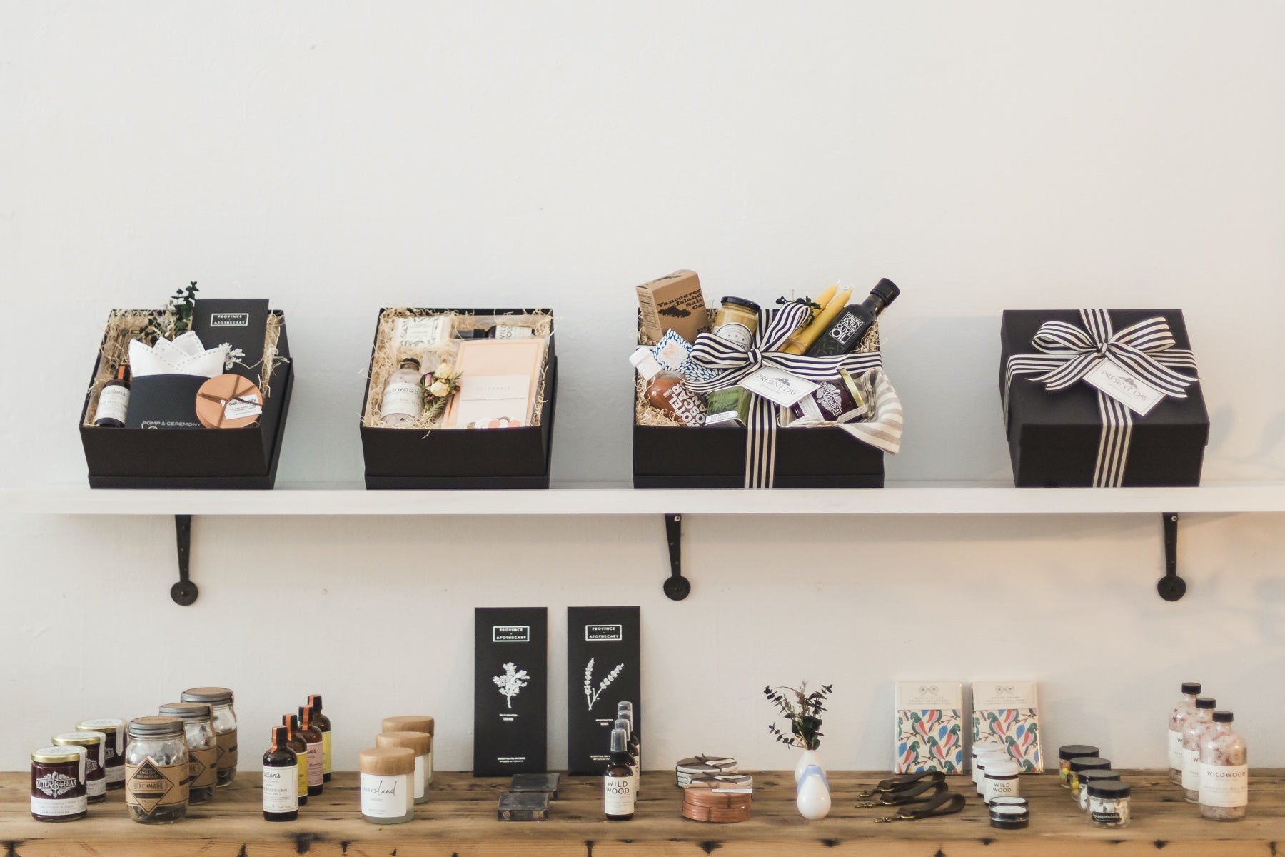 A retail store shelf lined with gift boxes and wellness products