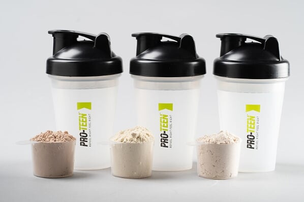 Three containers of various flavours of protein powder offered by Youth Sport Nutrition. 