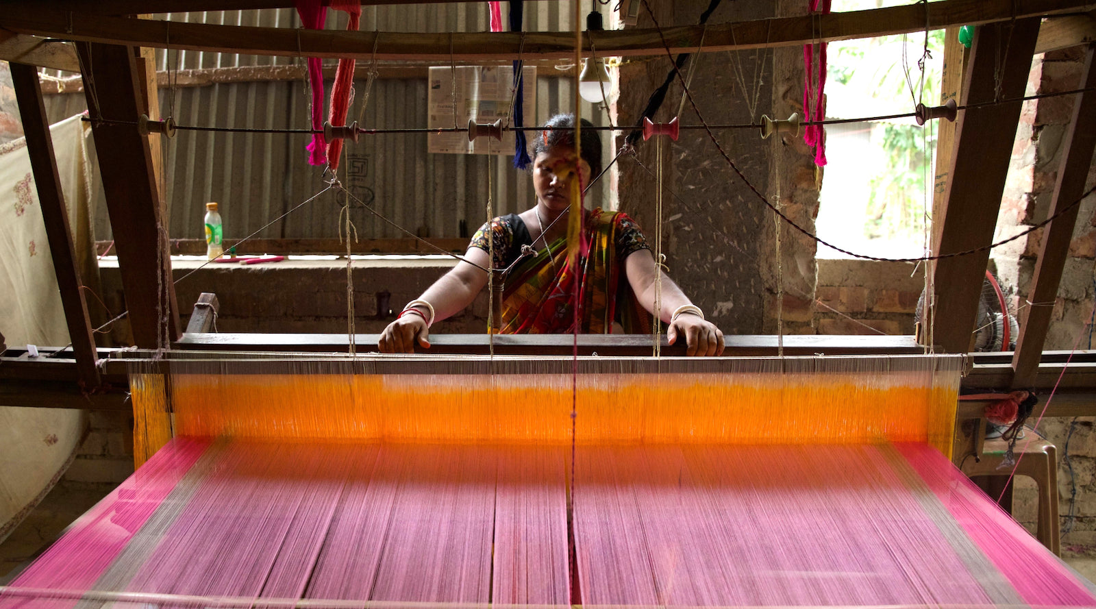 One of Suta’s 14,000 weavers at work on the loom.