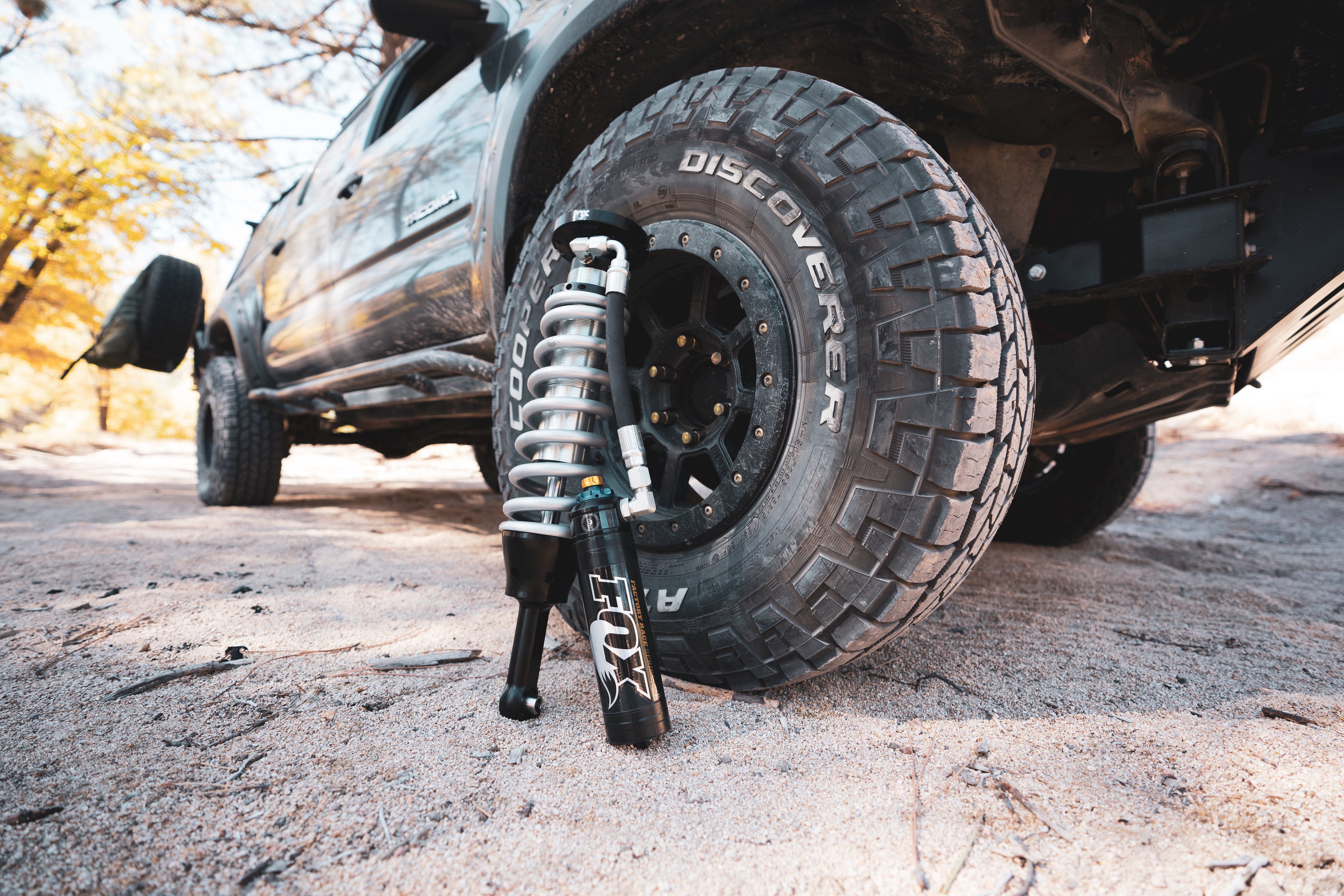 One of Shock Surplus’s performance series coilovers and shock sets on a tire. 