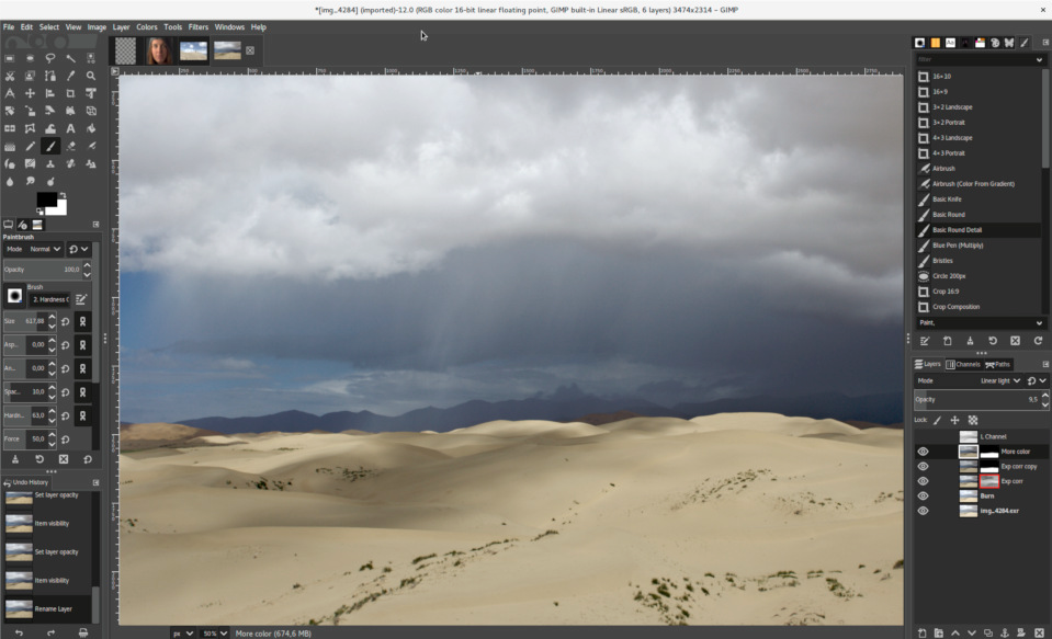 GIMP photo editing software interface showing tools and a sandy beach with dark sky